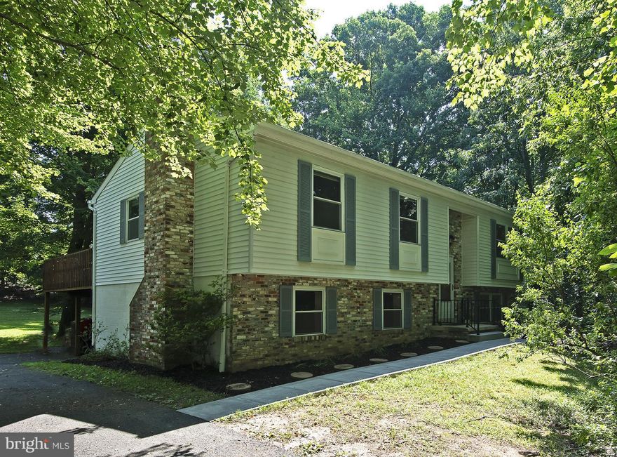 Private retreat - beautiful lot & outdoor living space, yet easy access to commuter routes.  Master.Suite upstairs and down! This welcoming and well maintained home is ready for YOU!  Newer HVAC, New microwave, and newer dishwasher and stove. New paint, newer Carpet; some brand new!  Custom deck, paved driveway, and sought after Kettle Run HS neighborhood. Over 2,100 finished sq.ft.!