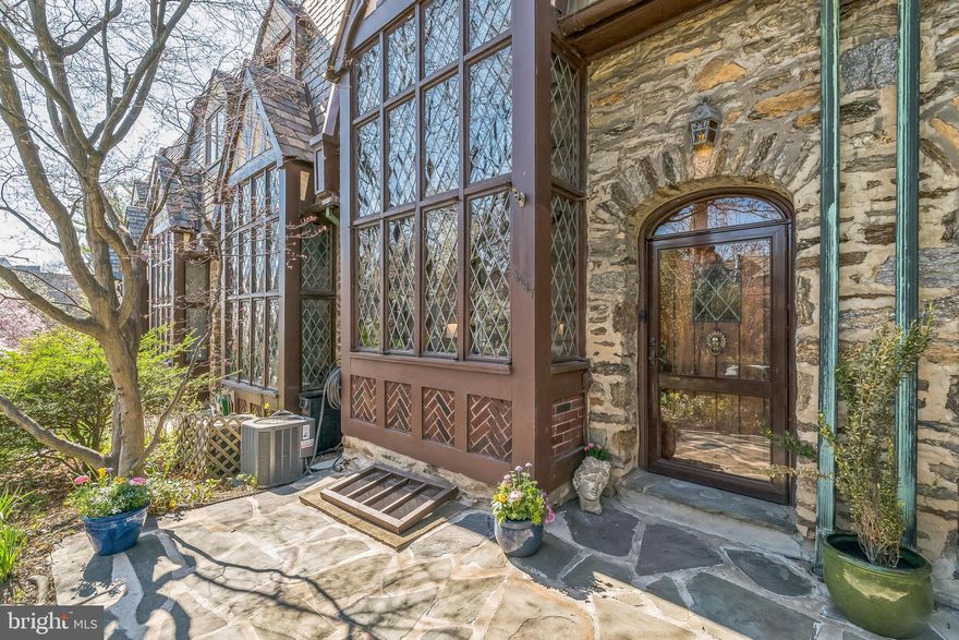This lovely Tudor is located on the historic register, ensuring that the whole row will retain its special character and integrity. This particular property was featured in a book of significant historic architecture of Philadelphia. Set back from the street, a short set of stone steps leads you to the front garden, full of mature perennial plantings and complimented by a small stone patio. The original leaded glass windows and beautiful solid wood front door set the tone for the interior. Inside, the soaring ceiling and corresponding two-story window wall create a dramatic living room. There is plenty of room for seating, including a recess along the front bay window. At the far end of the space, the ceiling height changes to create a cozy nook featuring the magnificent wood burning fireplace and wood-paneled wall. Architectural elements including the wood timbers and arched doorways abound and the wood floors in most areas of the home are rare 1.5” wide planks you almost never see today.
The dining room is graciously sized and can fit a large table as well as a sideboard and is thoughtfully outfitted with LED accent lighting to highlight art on the walls. It opens to the compact (but surprisingly efficient) updated kitchen. Stainless steel appliances and granite countertops meet today’s standards and everything is within easy reach. Beyond the kitchen is a first floor powder room cleverly designed so as to not cut into the garage space beyond—this property offers a full garage!
Upstairs, the landing doubles as an overlook to the two-story living room. The rest of this floor is occupied by the owner’s suite with an updated, skylit bathroom. The large deck accessed from the bedroom through French doors is a tremendous bonus space! The third floor offers two bedrooms that are actually large enough to be usable. (Some homes on this block have three bedrooms in the same space.) One of the bedrooms has a built-in window seat in the dormer in keeping with the historical nature of the house. The third floor bathroom is classic black and white and also features a skylight.
The basement has a finished area which includes a sauna. Freshly painted, it makes for a great playroom, overflow guest space, an office or whatever you need. The unfinished section houses the laundry, and utilities with plenty of space for extra storage. There is also a door leading up steps that lead to the kitchen door and alley behind the house.
This prime East Falls location puts you within walking distance to the library, parks, coffee shops, retail stores, restaurants and trails. It’s only an 8-minute walk to the train and there is easy access to Fairmount, Center City, University City, Chestnut Hill and the Main Line with low taxes, your own garage (plus extra deeded parking space) and unbeatable curb appeal. Sellers have had a pre-listing inspection and addressed all significant findings, including the removal of all knob and tube wiring and grounding of all outlets in the house.