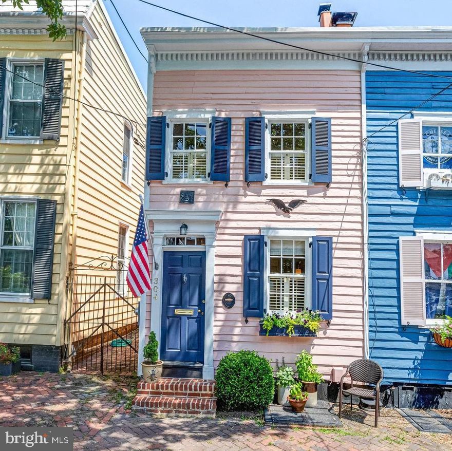 Located on a picturesque street in the SE Quadrant of historic Old Town Alexandria, this end-of-row historic jewel box is overflowing with charm and modern updates.  Built in 1870, the main level features original wide-plank hardwood floors, a living room with a wood burning or gas fireplace, dining room with built-in cabinets, and a gourmet galley kitchen which leads to the fully fenced patio.  The upper level offers 2 spacious bedrooms, 1 full bath, laundry and ample closet space.  Vaulted ceilings and a hallway skylight create a light-filled, airy feel throughout the home.  An unfinished basement provides extra storage. Positioned just 2 blocks to the shops and restaurants on King Street, the waterfront and Mt. Vernon Trail you can enjoy walking to all of the delights in Old Town. This special home is not to be missed!