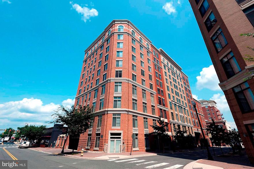 This one has it all! Located on a pretty-tree lined street, just a block from Clarendon Metro, and steps to restaurants, shops, Trader Joe's & more! This spacious 930 square feet unit offers 2 Bedrooms, 1.5 bathrooms and a balcony with great views! Light-filled open floor plan featuring hardwood flooring, gas fireplace, and gourmet kitchen with large island, granite countertops, abundant wooden cabinetry with custom built-in storage. The master bedroom features an en-suite bathroom and walk-in closet with Elfa-shelf system. Second bedroom perfect for an office with half bathroom attached. Convenient in-unit washer & dryer, assigned garage PARKING space & extra storage! Great community amenities include secure entry, on-site manager, outdoor pool & clubroom. In an unbeatable Arlington location, don't miss this fabulous unit!