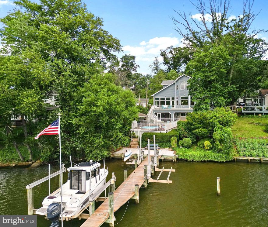 Captivating Manhattan Beach Waterfront Residence – A Scenic Retreat along the Magothy River! Discover waterfront living at its finest with this gorgeous and turn key, 6 bedroom, 4 bathroom home built in 2015, offering stunning vistas of the Magothy River. Your very own private waterside decks and waterside pool provide the perfect vantage point to enjoy this summer. As you step into the foyer, you're immediately greeted with breathtaking 180° panoramic waterfront views. This craftsman-style home boasts beautiful hardwood floors, high ceilings, an open concept and neutral color pallet. The open and inviting layout seamlessly connects the gourmet kitchen, living room, and dining areas, all graced by vast windows that frame the beautiful waterfront backdrop. The kitchen is a culinary enthusiast's dream, featuring an oversized island with seating, high-end appliances, crisp white cabinetry, elegant granite counters, and ample storage space. With walls of windows and doors leading to the rear deck overlooking the river, you can effortlessly transition between indoor and outdoor living. A convenient main level bedroom and full bathroom complete the main living level. Traveling up to the bedroom level you'll find 3 additional bedrooms and 2 full bathrooms plus a spacious laundry room and added storage areas. The primary suite is a true sanctuary that maximizes water views while featuring a large, custom walk-in closet and private en suite bathroom with soaking tub, dual sink vanities and an oversized shower. The lower level offers a rec room, second kitchen, an additional bathroom, a wine cellar plus a wealth of oversized storage/workshop space and presents limitless possibilities.  Outdoor living is unmatched with waterside decks, pool with cabana area, lower level screened in porch overlooking the pool and river plus turf artificial grass for easy maintenance.  As a boater's paradise, you'll enjoy easy access to the dock equipped with boat lifts all just a short ride to the river and an array of waterside restaurants. This exceptional property is a rare find, offering a perfect blend of modern comforts and timeless riverfront serenity. A perfect home for the true water enthusiast! Schedule your private showing today! **Manhattan Beach offers a voluntary community association with private beach access, playgrounds, water access, kayak/SUP storage & more! Severna Park Schools