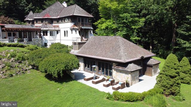 Located on a private road of only five residences, in the heart of historic Birchrunville is a 5 acre European chateaux inspired magnificent estate Designed by architect Paul Macht, and crafted by Alan Entrekin, this one of a kind custom home is designed to integrate the owner w/nature while utilizing the most advanced "Green" technology and building systems. From the prefabricated walls offering staggering insulation values, to the indoor- outdoor pool heated by an advanced geothermal heating system. Encompassing over 7,000 square feet of living space, this remarkable home is graced by soaring ceilings, breathtaking architecture, the finest of custom millwork, and wall-to-wall windows. The house is truly best characterized by the casual and comfortable feel of a well thought out design that connects its essence to it's surrounding bucolic setting. Featuring 5 BRs 4 w/private BA,, stunning millwork library, elevator, and 5 balconies. Over $60k in recent upgrades and improvements, just to mention a few are the Sonos sound system, and Nest thermostat for the full itemized list see Documents. Lower level includes an in-law suite with full kitchen, movie theater with automatic shades, and indr/outdr pool. Conveniently located within walking distance to the Birchrunville Post Office, restaurant, and cafe, and a short drive to route 100 and the PA turnpike.