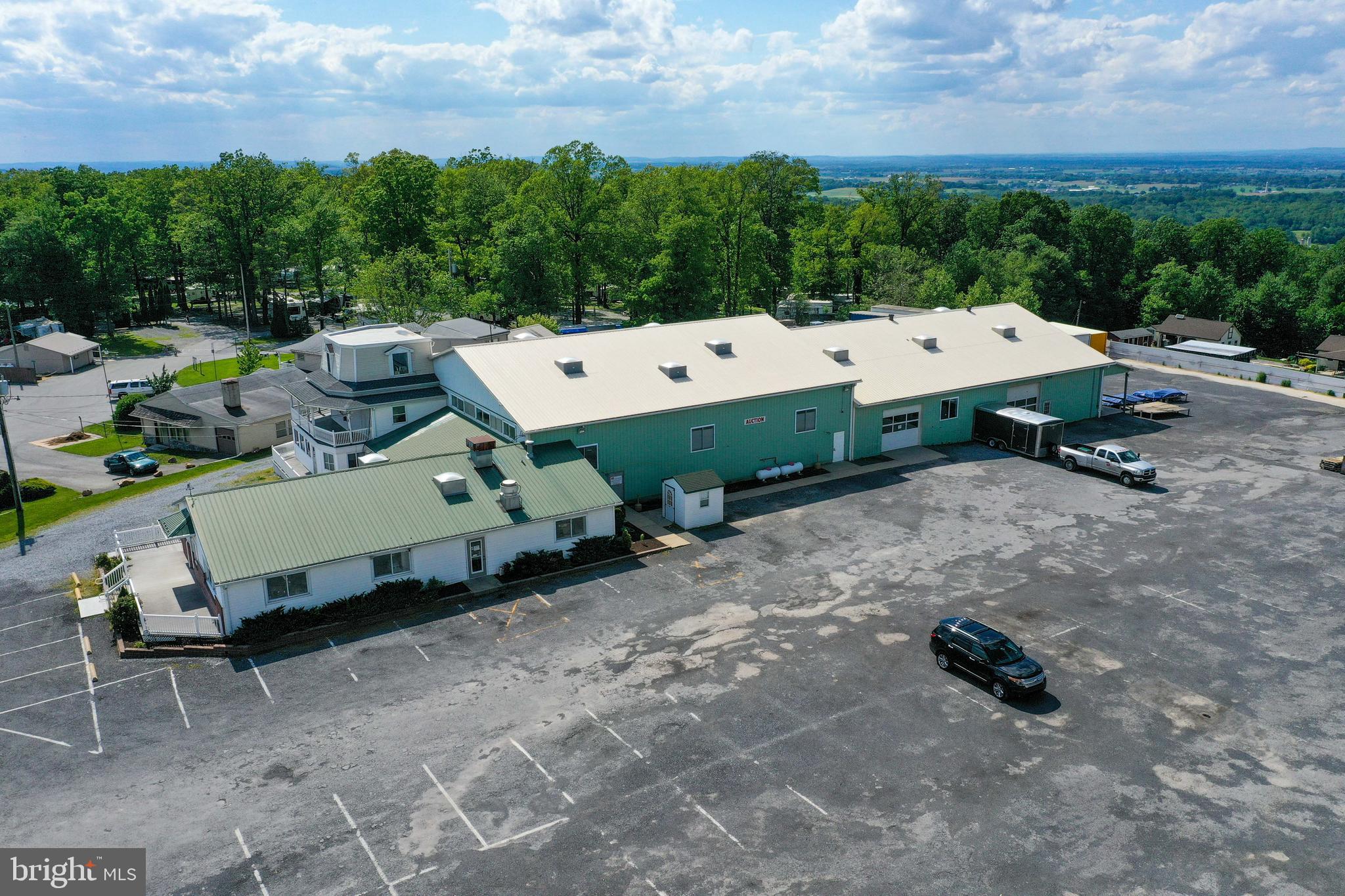 Total of 5.3 acre property with an additional 3 acre parcial available if desired. A large building with approx 17,000 sq. ft of finished space. (approx. 11,000 sq. ft Total sq. ft has 14' & 17' ceiling height, the rest has 8-10 ceiling height). This building had a large wrap around, exteriorloading dock w/roof and a total of 12 dock spaces. The main entrance by the office/cafeteria has a deck area w/wheel chair ramp. Building has a fully functioning cafeteria (equipment reserved). Property features a large gravel parking area with approx. 130 parking spots as well as a fenced storage lot. Building is currently being rented and used by an auction company. Property is well maintained and suitable for many uses.