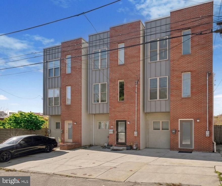 Step outside your door this spring/summer and experience the vibrant energy of Manayunk — from iced lattes at local cafés and lively evenings at neighborhood bars to scenic strolls and bike rides along the canal, plus weekend brunch on Main Street. Perfectly positioned on a quiet, flat street, this modern end-unit townhome blends urban convenience with refined comfort. A rare find in the area, this residence features a private two-car driveway, classic brick façade, and soaring 9-foot ceilings. The open-concept main level showcases hardwood floors, a sun-drenched living room, and a chef-inspired kitchen with Frigidaire stainless steel appliances, granite countertops, subway tile backsplash, new under-mount sink, Moen faucet, garbage disposal, and a spacious pantry. Step out to the balcony — perfect for morning coffee, summer grilling, or unwinding in the fresh air. The second floor offers two spacious bedrooms with generous closets and abundant natural light, along with a beautifully refreshed full bath featuring a modern vanity, tiled tub/shower, updated fixtures, and a timeless neutral palette. A hidden laundry closet adds everyday convenience. The third-floor primary suite is a private retreat with a custom walk-in closet, spa-inspired bath with a stone-floor shower, and its own terrace. A spiral staircase leads to the expansive rooftop deck with breathtaking 360° views—ideal for sun-soaked afternoons, sunset happy hours, and warm summer nights under the skyline. The fully finished walk-out lower level is designed for entertaining, complete with a custom wet bar and a newly renovated full bathroom with a fully tiled shower and modern vanity—perfect for guests or an in-law setup. It opens to a private courtyard, ideal for outdoor dining, summer gatherings, or relaxing evenings under the stars. Recent upgrades include a newer Lennox HVAC system, Smart Honeywell thermostat, Bradford White hot water heater, and radon remediation system—offering efficiency, comfort, and peace of mind. Just minutes from Main Street’s boutique shops, award-winning restaurants, and seasonal events, this home offers easy access to I-76, Kelly Drive, and regional rail—making it a breeze to enjoy everything Manayunk has to offer while staying connected, only 20 minutes to Center City and 90 minutes to NYC or the Jersey Shore. Welcome to 4128 Apple Street — where modern luxury meets vibrant Manayunk living all year long!