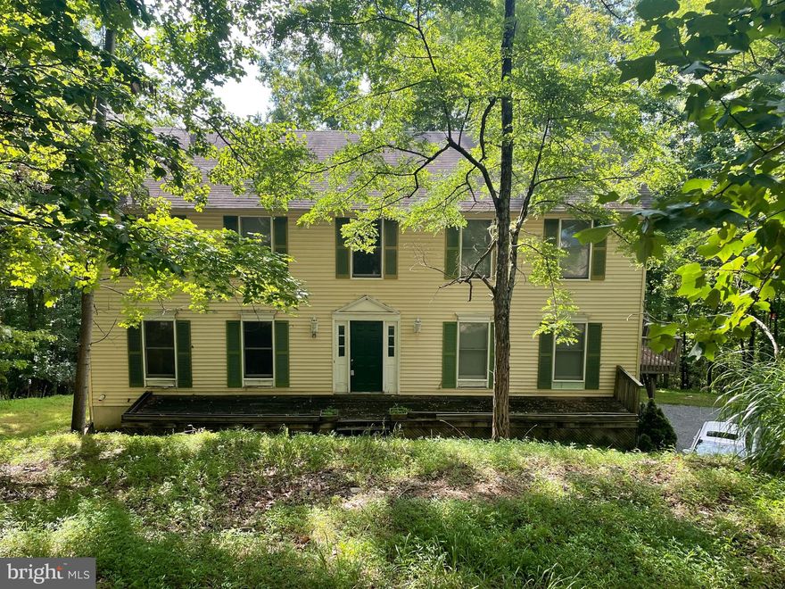 You will not want to miss this amazing opportunity in Bull Run Mountain Estates. This single family home sits on 2.68 acres. Main level features living room with wood burning fireplace, den, dining room, laundry, and kitchen. Main level has a half bath that has been removed to studs and is ready for remodel. Upstairs you will find 4 bedrooms and 2 full baths and loft area. Upstairs you will also find brand new Teak flooring that is almost 100% complete. Unfinished lower level walk out basement with rough in for bath. Central vacuum. Brand new instant on hot water system installed. 2 car garage and plenty of parking. Public water available for hook up. Comcast and FIOS high speed internet available for your home office and streaming needs. NO HOA. Home needs updating. Sold AS IS. Come fall in love.