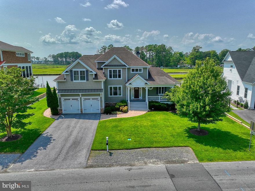 Back on the market with a fresh new look! 
Welcome to your waterfront retreat, 49 West Side Drive in RBYCC! This fabulous home boasts a large, open floor plan featuring two-story ceilings in the great room with built in bookshelves, a gas fireplace, and views of White Oak Creek. A newly updated chef's kitchen is adjacent and offers a 5-burner gas cooktop, wall oven, gorgeous white quartz countertops, walk in pantry, and a large island where everyone can congregate.  An extended sunroom showcases views down the creek featuring breathtaking vistas of the Rehoboth Bay and Indian River Inlet Bridge. Just beyond the sunroom is a welcoming screened porch - the perfect place to enjoy your morning coffee or sunset cocktails. The generous owner's suite is located off of the great room, featuring tray ceilings, large windows, and more water views. A hallway leads to two walk-in closets and the newly renovated primary bath with 2 quartz-topped vanities, a gorgeous custom-tiled shower with rain-shower fixture, heated floors, Serena and Lily wallpaper, and a large soaking tub. All fixtures and finishes have been thoughtfully updated from ceiling to floor! 
In the rear of the bedroom, a door leads to the expansive deck with gas firepit and gorgeous water and marsh views. Additionally on the first floor, you will find an office which could easily be converted to a 5th bedroom, a 2nd full bath, dedicated laundry room, and a dry bar with built in wine fridge. A wide and open staircase leads to the second floor which offers a second primary suite as well as two additional bedrooms with a shared hallway bath. Tired of paying high electric bills? This home has solar panels which are owned, providing more than enough energy to power the house year-round. Reported electric bills average $25! The backyard allows for plenty of room for activities and a new dock with electric boat lift and jet ski lift will keep your water toys high and dry when not in use. There is also a floating dock for launching kayaks and paddleboards. A two-car garage allows for ample storage, as does the crawl space. Other perks include custom plantation shutters and window shades, tankless hot water heater, built-in sound system in the great room and on the rear patio, and hardwood floors in the main living areas. All furniture is staged and most of it is available for separate purchase. 
Rehoboth Beach Yacht and Country Club is a highly desirable community with easy access to downtown, shopping, and restaurants. 
Schedule your tour today!