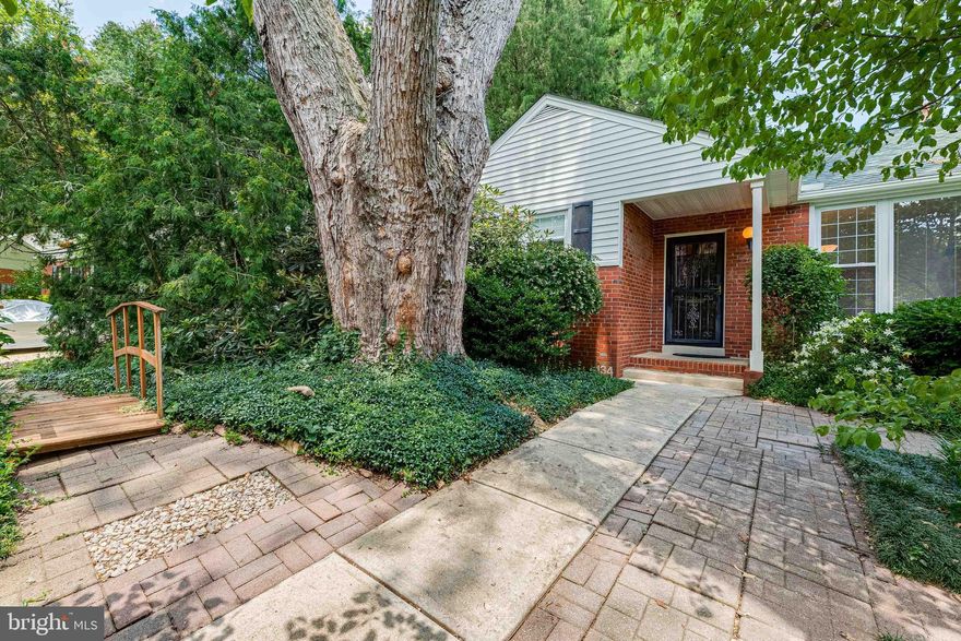 Your very own private oasis! You'll instantly fall in love with this beautiful brick front Ranch style home nestled among the trees and surrounded by beautiful landscaping on .31 acres of land. Plenty of room for you and your family with 3 bedrooms, 1.5 bathrooms, and 1,736 sq ft of space. Walk into the spacious living room that features hardwood floors and large windows letting in streams of light. Easily entertain guests for dinner in the formal dining room that features hardwood floors, chair railing, and 5-light brass chandelier. Two entrances off the dining room, one that leads to a utility room with built-in shelving, sink, and second exit, and a second entrance with French double doors leading into the kitchen. The kitchen features recessed lighting, cooling ceiling fan, shiplap walls, and plenty of counter and cabinet space, including an island with breakfast bar. Also features a large sink with side prep sink, and glass display cabinets with built-in sideboard and workstation. Two glass paned doors lead to the backyard and let in streams of natural light. Take the side door that leads to a spacious 3rd bedroom with a cooling ceiling fan and lots of windows with natural light, plus a half bath. Two bedrooms feature hardwood floors and large closets, and the main bedroom suite features an en-suite bathroom with tub shower. Enjoy the beauty of nature in your private, fully fenced-in backyard, that includes a garden shed for all your storage needs. Plenty of room for parking with the long wide driveway. Near Route 66, and minutes away from Tysons Corner Center - you won't want to miss this one!