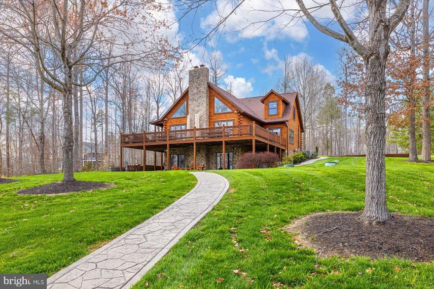 Relish in the unhurried moments of waterfront living at Lake Anna, Virginia.  The possibilities are limitless at this luxury waterfront home, featuring 200 feet of shoreline, deep water, and located in the most desirable subdivision on the private side of the lake: The Waters At Lake Anna. Whether you're looking for the perfect weekend escape, a relaxing primary residence, or a powerful investment asset, this property will meet everyone's needs.  Furniture and other items can convey with appropriate offer.  High speed fiber internet by iWisp.  With almost 4,200 square feet spread over three levels, this exquisitely-maintained log home offers ample space for entertaining, relaxing, and enjoying stunning water views.  Unplug in your great room, with its soaring cathedral ceilings and large windows showcasing views of Lake Anna that immediately set the mood.  The main level also offers two large master suites with oversized bedrooms, double vanities, gorgeous walk-in showers, large soaking tubs, and walk-in closets.  The kitchen is also within the main level open floor plan, where you'll find granite countertops, a double wall oven, plenty of cabinet storage, and an island with barstools.  Upstairs, your guests will enjoy their own private water views from two additional bedrooms overlooking the lake, along with a full bath and spacious loft area, ideal for afternoon reading or playing games.  Downstairs, the large finished walkout basement is outfitted with a beautiful pool table, movie theater room, an additional big bedroom with bunkbeds, full bathroom, and storage room.  The massive wrap-around deck with BBQ grills and patio furniture is the perfect place to unwind at the end of the day, take-in the water views, and watch American Bald Eagles glide by (yes, Bald Eagles).   Follow the beautiful hardscaping down to the water's edge and you'll find your massive two-slip boathouse, fully equipped with a kitchenette / tiki bar with roll-up doors and separate storage room.  Grab an afternoon nap on your massive sectional couch on the boathouse, or play cards while enjoying a cocktail at the table.  Your shoreline also features a massive private sandy beach protected by beautifully arranged rip-rap stones, a large hardscaped fire pit, and the well-manicured landscaping throughout the property, which shows the sellers have spared no expense here.  Investors, this home can generate massive income via short term rentals, which are welcome in this subdivision. The subdivision has a fantastic swimming pool, boat slips, boat ramp, tennis courts, clubhouse, and other fun amenities.  Excellent location: just 5-10 minute drive to groceries, restaurants, ABC, nail salon, vet clinic, Lake Anna Taphouse, coffee, The Yacht Club, and more!