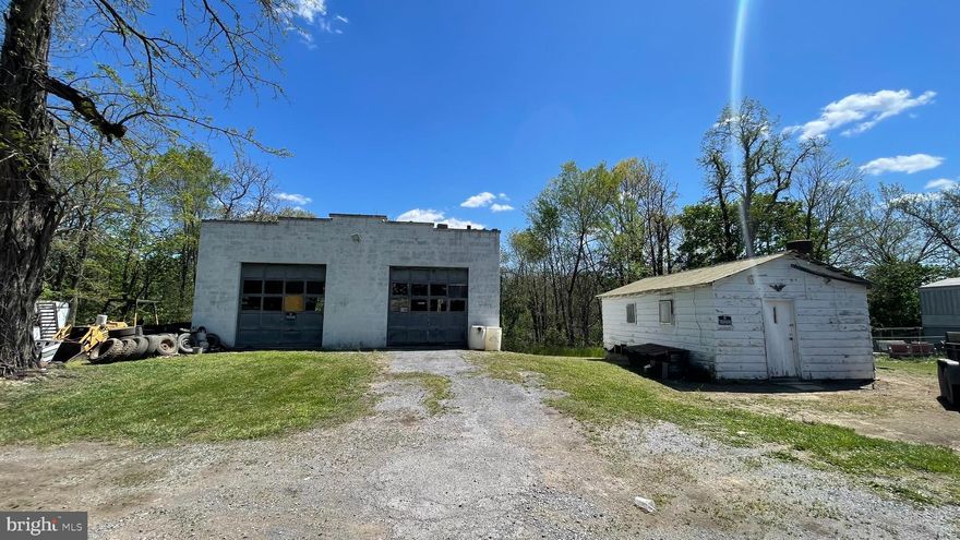 Approximately 2.3 acres comprised of 21 parcels, most likely created for mobile home use.  Property is presently improved with a 36x34 two-bay shop with service pit, a 14x24 detached office and a rented 60' mobile home.  Buildings are in fair to poor condition.   Located in Berkeley County, bordered by City of Martinsburg on three sides, this property has no zoning.  Water, sewer, power all are all located at the site.  This is a great opportunity to redevelop for multiple multi-units, commercial, mixed use or mobile homes with county approval of purchaser's site plan.  Buyer or buyer's agent to confirm all dimensions, square footage, taxes, etc... Seller and seller's agent not responsible for buyer's due diligence.
