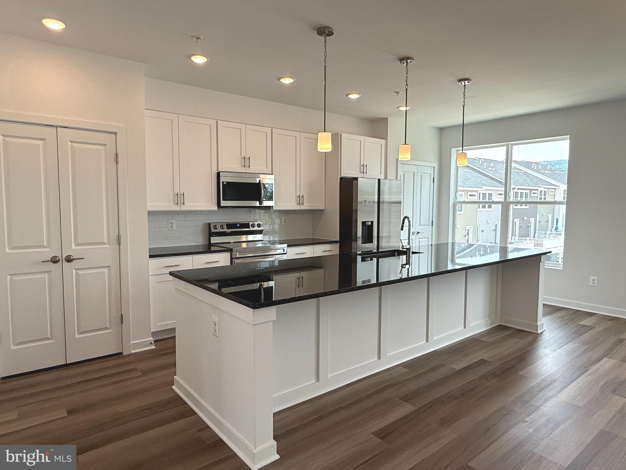 Estes Park in the new community of Gambrill Glenn offers a spacious 2-level condo with 3 bedrooms, 2.5 bathrooms, and 2200+ square feet of modern living. The unit has a private front entrance and an attached 1-car garage in the rear. With no shortage of windows, this unit is light filled and welcoming. The gourmet kitchen includes a huge 12-foot center island, with space for extra seating making it perfect for entertaining and gathering. The open concept floor plan features dining space off the kitchen, a family room complete with a built-in electric fire place, an office nook, walk out balcony and a main level powder room. Upstairs, the primary bedroom includes a private, covered walk-out terrace, walk-in closet and an ensuite bath with double vanity and walk-in shower. Just down the hall are two additional spacious bedrooms, a second full bath, and a laundry area. A brand-new washer & dryer will be installed with the new tenant. Enjoy 7-inch wide, luxury vinyl plank flooring, white shaker-style cabinetry, granite countertops, and stainless-steel appliances. Located just minutes from downtown Frederick and all the shops, restaurants and entertainment the city has to offer! Easy access Rt 15, I-70 and I-270.