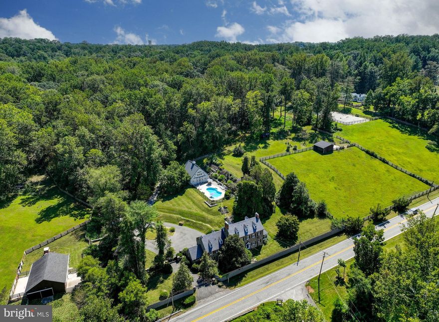 Live authentically. Quintessential stone farmhouse circa 1800 on 14.65 acres of rolling pastoral land. This piece of history has been lovingly restored with original details intact. A very functional farmette with three pastures, five stall barn, run-in shed & fenced exercise arena. Incredible party barn with loft and a plethora of possibilities. Sublime sparkling pool perched with a view... truly an oasis. Float while you gaze at your four legged friends. Five fireplaces. Very special setting that exudes soul and captures your heart. Subdivision potential. Cultivate your existence. The art of uniting human and home.
• 3.5 baths
• 3 renovated bathrooms
• 2 bathrooms with bidets 
• New kitchen 
• All new appliances
• 2022 Slate roof 
• Jacuzzi tub
• Saltwater pool