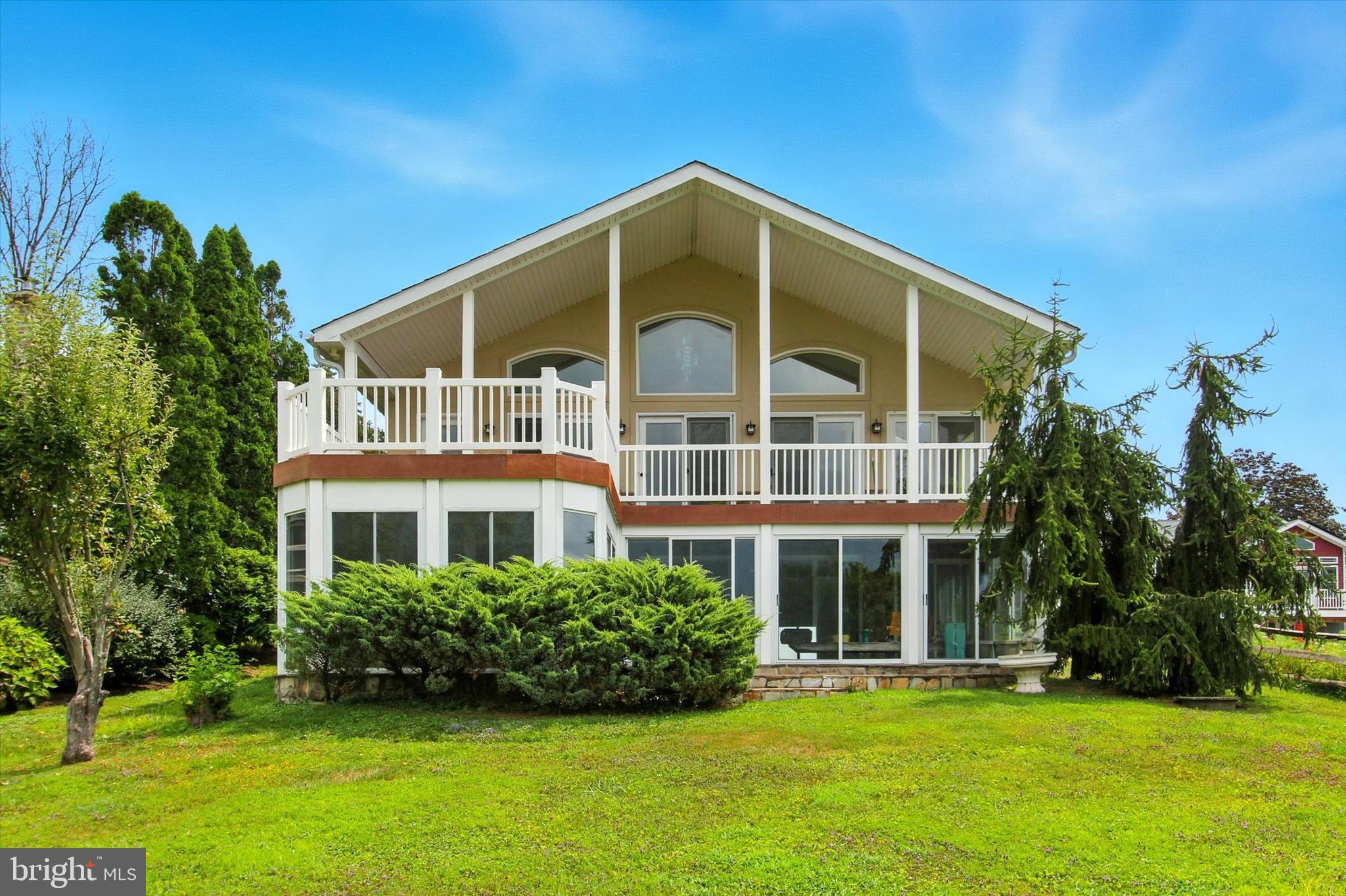 Very rare Lake Heritage lakefront listing with 5464 sqft of living space in main home, plus charming 1 bedroom apartment over 4 car detached garage with 3 gorgeous wooden carriage doors. Including apartment, this home offers 6 bedrooms, 4.5 baths. Enter a tree-lined driveway to front door, where main level includes huge great room with floor-to-ceiling stone-front gas fireplace, upgraded kitchen/dining area, family room with gas fireplace, rec room , 1/2 bath and primary bedroom with full artistically-painted and tiled primary bathroom, all with a stunning lake view! Second level has 2 bedrooms and 1 brand new beautifully tiled full bath. Lower walk-out level has yet another rec room, with gas stove, 2 more bedrooms, a den and another brand new upgraded full bath. Upper level composite deck looks out over lake and under it is a 3 season sunroom complete with hot tub. Apartment has cathedral ceiling and open floorplan, with bedroom area, living area, with gas stove, full bath and kitchenette area. Dock comes complete with a lift. Be sure to check out the storage area accessed from the the middle outside door on front of house, as well as the huge storage closet in great room and huge storage area accessed from 3 season room. Lake Heritqge, conveniently located just off Rts 15 and 97 for easy access, includes a 150 acre lake for water skiing, fishing, boating of all kinds, olympic-sized pool right on the lake, community center, playgrounds, pavilions, dog parks, walking trail, basketball court, beach volleyball, tennis/pickleball court, clubs and more. This is a must see for the discerning buyer!