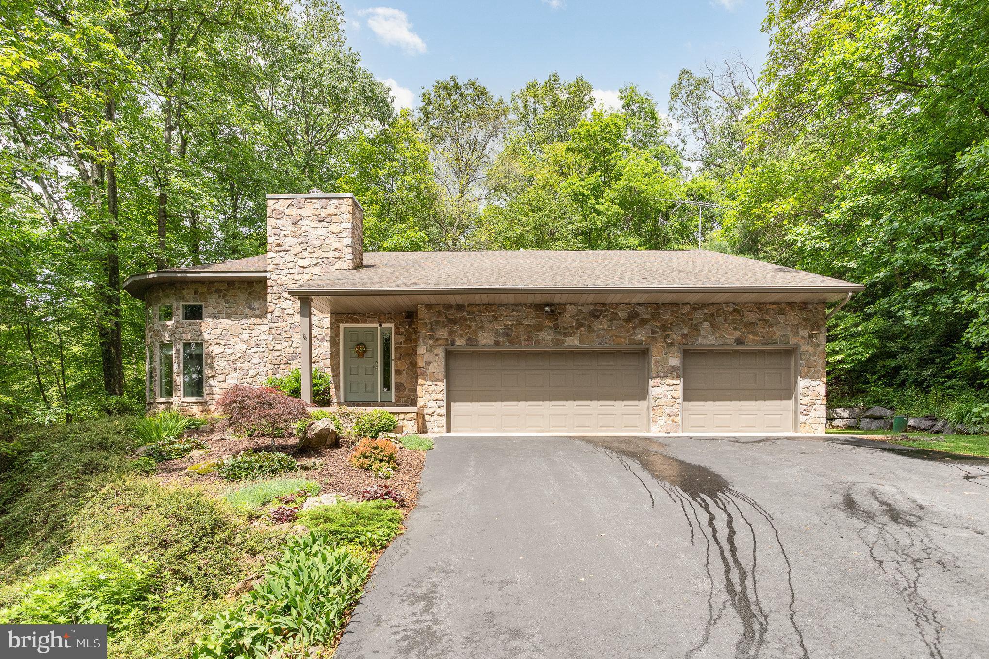 Nestled on 2 secluded acres, this enchanting 4-bedroom, 3-bathroom contemporary retreat offers a rare blend of modern elegance and serene natural beauty. A gently rising driveway leads you above the public road, where the home is tucked away in peaceful privacy, surrounded by lush landscaping and the quiet rustle of trees. Inside, soaring ceilings and an open layout invite sunlight to warm across brand-new floors, while the kitchen gleams with 2024 granite countertops and stainless steel appliances. Thoughtfully designed for effortless one-floor living with the primary on the main floor, this home is as practical as it is poetic. Step outside to birdsong and breeze, with nature wrapping around you like a warm embrace. Whether you're sipping coffee under the covered patio out back or stargazing in the stillness, this is a place to breathe, dream, and truly feel at home.