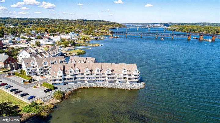 Open House Sunday, August 17, 2025, 12-2 pm.
This is the one you've been waiting for! End of group WATERFRONT condo with an ELEVATOR that stops at both floors! ENJOY WATERFRONT LIVING with million-dollar panoramic views in this awesome 3 BR/2BA TOWNHOUSE STYLE CONDO in a great historic boating town located on the Susquehanna where the River meets the Bay. Located in the CENTER OF HISTORIC HAVRE DE GRACE, this rarely available STUNNING 2000 sq ft end-of-group WATERFRONT townhouse style condo features a fabulous 50-foot WRAPAROUND DECK, a 2-car front/back garage PLUS a 10x9 storage room, and a separate utility room. Tons of storage! This amazing property has three Bedrooms and two full baths (one BR currently used as an office/family room with impressive built-in cabinets), and a two-car tandem garage on the ground level (one garage space currently used as storage and cedar closet). Enter the condo via the steps or the elevator. The main level is the star of the show with three sets of sliders opening onto the waterfront wrap-around deck with views of the river, flats, and the bay! The KITCHEN features stainless steel appliances, plenty of cabinet space, and opens to the dining room with awesome views! Take the steps or the elevator to access the upper level, which features two bedrooms, a jack-and-jill bath, ceiling fans, and walk-in closets. The Primary Bedroom also features a private waterfront deck! The bathroom features a soaking tub, a double sink cabinet, walk-in shower, a private water closet and the elevator access.
Meticulously maintained! Recent updates include hot water heater (2025), kitchen appliances (2022), HVAC (2019), maintenance-free decking (2017), deck awnings (2017), sliders & storm door (2018), & windows in TV room & 2nd BR (2023).
SENECA POINTE FEATURES a BEAUTIFUL COMMUNITY POOL and GAZEBO for residents. The Condo fee INCLUDES pool maintenance, roof and exterior maintenance of the condos, FLOOD INSURANCE and trash pickup. WALK EVERYWHERE! Havre de Grace features First Fridays, a Saturday Morning Farmers Market, Thursday night sailboat racing, a waterfront Promenade, live music, the Arts, parades, festivals, fireworks, restaurants, shops, bars, and marinas all within walking distance of this condo. The town was named one of the 10 Towns in Maryland with The Best, Most Lively Main Streets, as well as one of the Best Small Towns to Visit by the Smithsonian! Easy access to I-95, APG, Amtrak, BWI, and Philadelphia airports. Live where you love to play in this carefree community! You'll feel like you are on vacation year-round! A very special opportunity! A MUST SEE!