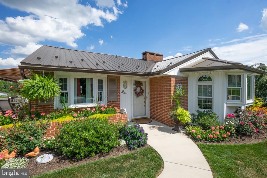 This home is a one of a kind.  Totally remodeled, it features lovely bump out, enlarged living room with brick gas fireplace & bay window,  The dining room and kitchen have vaulted ceilings, beautiful laminate floors, kitchen recessed lighting and 2 sinks- I large deep main sink and a second smaller sink, foyer just inside level entry (perfect for wheel chair access) is ceramic tile, 3 carpeted bedrooms with hardwood flooring under the carpet,pull down steps in hallway to access attic, and updated bath with barn doors. Downstairs is a walkout with 2 exits and garage access.  It also has a full bath , nice family room with wood burning fireplace and nice patio doors to rear, private patio. So much to mention!! Outside features nice side deck, beautiful landcaping, outdoor fireplace, carport and an additional garage and sheds to store the extras. Come see it all in person.  You won't believe your eyes!