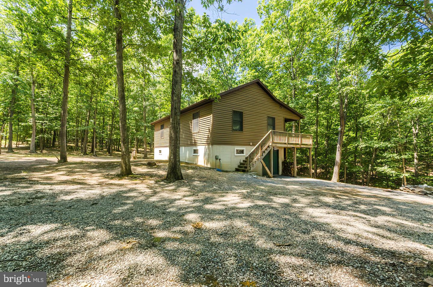 Perfect cabin to get away from it all and right across from the Potomac River. This well maintained rancher boasts 2 bedrooms, 1 full and 1 half bath. Three different kinds of heat - Gas, Wood and Electric and the Central A/C. Is only 2 years old. Wood Stove is only 4 year's old Walls are built with 2x6's. There is 6" of insulation in the walls. 12" of insulation in the attic. Windows are vinyl on the outside and wood on the inside. All appliances - Upstairs refrigerator, Stove, Microwave, Washer/Dryer and Basement refrigerator go with the house. The stand up freezer in the basement does not stay. There is a 10 x 40 deck off the front of the house. 10 x 20 of it is screened in and leads directly into the house.There is a 1/2 bath in the basement. The water well is 260 feet deep and produces 30 gallons. All on 12.89 acres.