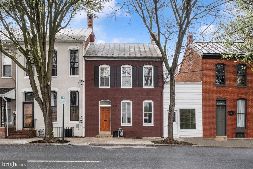 Located in the heart of the Frederick Historic District, this beautifully renovated 1900s Federal-style row home blends timeless charm with modern luxury. Offering approximately 2,000 square feet of finished living space, this 3-bedroom, 2 full bath home has undergone a comprehensive custom renovation in 2026 with all permitted work completed.  Step inside to find bright, natural light throughout and a thoughtfully designed layout featuring a main-level bedroom and full bath—perfect for convenience and flexibility. Upstairs, you’ll find two additional bedrooms, a second full bath, and a dedicated laundry area. A bonus room on this level provides ideal space for a home office, studio, or flex use. The home continues to impress with an upper-level balcony, attic space ready for your creative vision, and a large rear yard.  Off-street rear parking adds everyday convenience—an invaluable feature in this sought-after location.  An additional side building opens the door to endless possibilities, including retail, office, or potential ADU use (buyer to verify with the City of Frederick). No detail was overlooked in the renovation, with new systems to include HVAC, plumbing, electrical, natural gas water heater, Englert standing seam metal roof, paint, lighting, updated kitchen and baths, stainless steel appliances, and a new front door. Perfectly positioned just steps from North Market Street and moments from the scenic Carroll Creek Promenade, this home places you in the center of it all. Enjoy morning coffee from a local café, evenings strolling to award-winning restaurants, and weekends filled with farmers markets, live music, art galleries, and seasonal festivals. Downtown living here means leaving the car behind and embracing a vibrant, walkable lifestyle rich in culture, community, and convenience.

This is more than a home—it’s a lifestyle. Move-in ready with thoughtful updates designed for modern living and long-term comfort.

Check out the video on YouTube for 129 E Fourth St!
