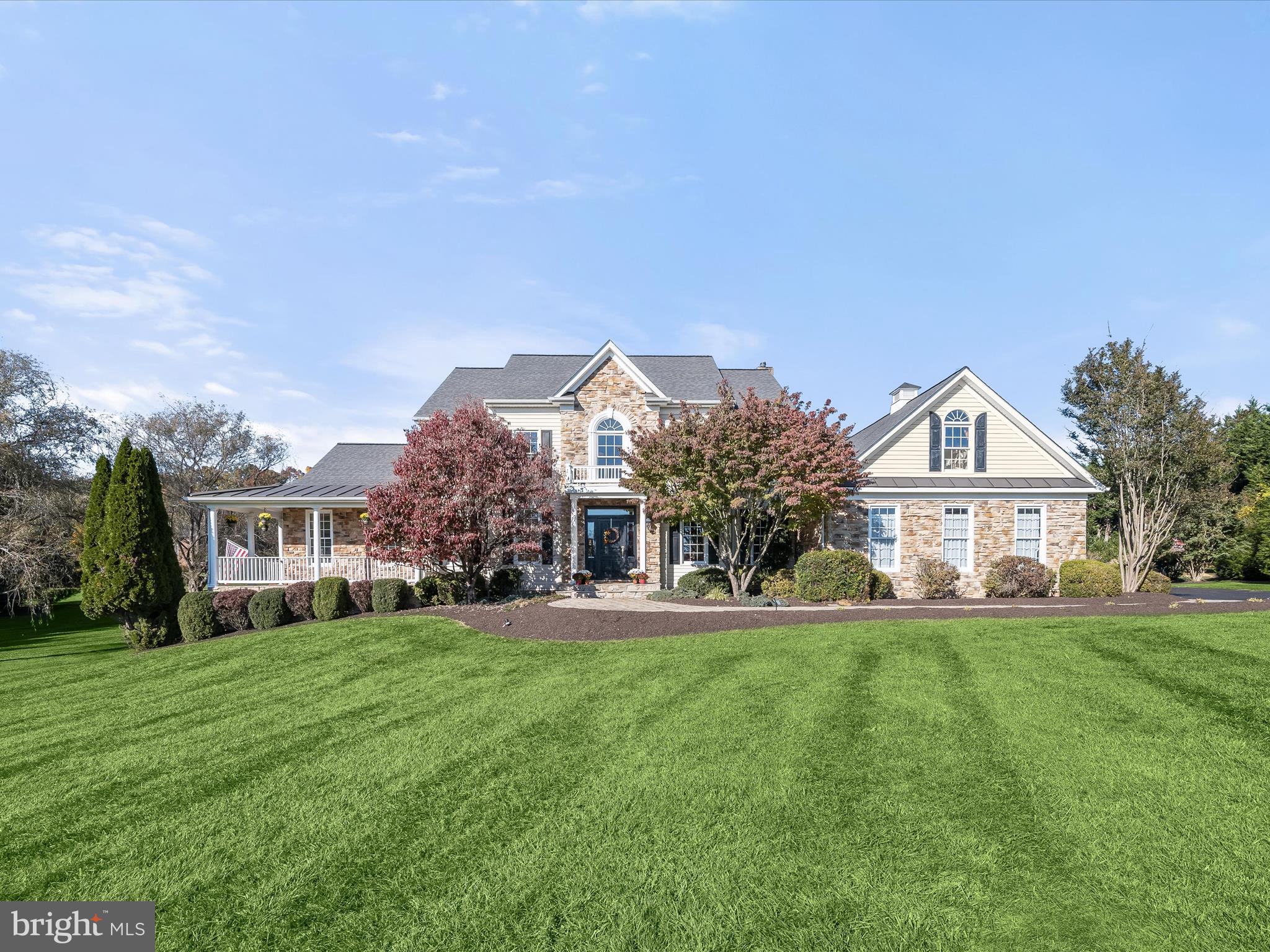 Nestled on over 2 acres of lush green grounds in the prestigious Wellington area of Glenwood, this home invites indoor and outdoor living and entertaining venues large and small. Outside, extensive paver walks escort guests to a covered stone front porch or a secondary side porch that welcomes family and friends. A hallmark wrap-around stone front porch in front, and a low-maintenance wrap-around rear deck, hot tub and screened porch overlook a glistening, heated in-ground pool with waterfall and spa.
Perfectly designed for robust living and entertaining, this majestic setting offers resort-styled outdoor amenities and interior spaces to accommodate lifestyle, flexibility and comfort. Inside, gleaming hardwood floors adorn the foyer, formal dining room, private study, and family room.
The open plan design showcases a gourmet kitchen with a commanding entertainer’s island at center, and a Wolf gas cooking station and range hood for the chef of the house. Plate your creations and dine formally in the dining room, casually in the breakfast nook, screened porch, or dine alfresco on the deck or poolside under the pavilion.
A primary bedroom and completely updated luxury bath suite are privately located in a wing on the main level with private access to the wrap around side and rear deck and hot tub. Special moments on the main level also include an open plan family room with a cozy stone fireplace, a sunroom with a vaulted ceiling and windows where light streams in to brighten each day. Relaxing days poolside, and action-packed fun days splashing in pool are low maintenance with easy access to a newly upgraded side entry mud room and laundry center where pool linens can be easily laundered. From the main level, there is also a secondary stair from the kitchen to the upper-level landing, adding private accessibility to four more secondary bedrooms, served by two adjoining dual entry J & J baths, and a private vanity for each bedroom.
Downstairs, a finished lower level features a recreation room with full daylight and a walk out slider door leading to a covered patio, and paver walk to the rear lawn, pool and pavilion. Guests will also enjoy a festive beverage from the wet bar, or wine room, and a game of pool in the adjacent billiards room. The lower level is completed by a dual entry full bath and private guest quarters.
Come home and decompress in the fold of extraordinary outdoor living spaces, lush, expansive grounds, mature trees and luxury interiors offering lifestyle options, flexibility and special moments at every turn!