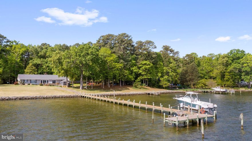 You can have it all! This property is a river playground offering big water views, pier with boat lift, two waterside decks, a screened gazebo and room to spread out. The property comprises two waterfront lots and an additional off-water lot for a total of 3.84 acres and over 300 ft. of water frontage. It is elevated out of the flood zone but offers an easy walk to the pier and waterside. Stunning river views greet you at the front door. This one-level home has a living room/dining room combo with big water views and a gas fireplace. The kitchen has bar seating, pantry closet and is open to a second sitting room. The primary bedroom en suite is on the waterside with water views from the bedroom & bathroom. A large utility room is used for laundry and can also function as a rec. room. The waterside offers a ton of social spaces connected by a boardwalk. The detached garage is deep, offering space for extra parking or water toys. The Corrotoman River gives you access to the Rappahannock River and The Chesapeake Bay. You can fish, crab and grow oysters right from your pier. The pier has water, electricity and boat lift. The entire shoreline is protected with rip rap.