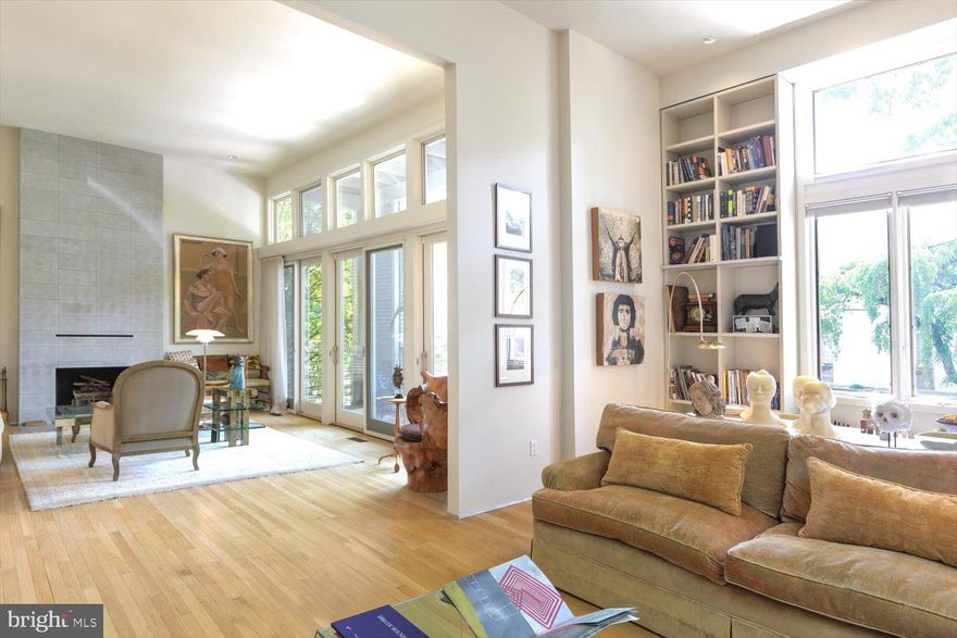 OPEN SUNDAY 1-3PM! - Motivated Seller!  Revel in the light-filled open spaces throughout this unique modern home. Art lovers rejoice! Showcase your art collection in large, gallery-style spaces with tall ceilings. The custom floating staircase at the center of the home is a work of art unto itself. A spacious entry foyer offers access to the one-car garage. The kitchen and dining room open to the lushly landscaped patio and garden featuring an in-ground pool and wisteria-draped pergola – perfect for relaxation as well as indoor/outdoor entertaining. The living room features a wood-burning fireplace, a wall of glass opening to a spacious balcony and extra tall ceilings. The adjacent library, with its wall of built-ins, also serves as a media room. The nearby primary suite, with its unique pivoting door, overlooks the garden. The spa-like primary bath is a true sanctuary. Next up you'll find a large sitting room with a wood-burning fireplace and balcony plus a bedroom with an en-suite bathroom. The next level offers a bedroom and full bathroom as well as laundry. Nestled on the top floor are a sitting room and bedroom. A large open room on the lower level offers many possibilities: Home gym? Art studio? Play room? Lovely white oak floors flow throughout the home. The property is sited on sylvan Bancroft Place, a quiet one-way street lined with stately homes and embassies. It is close to much-loved Mitchell Park and convenient to many restaurants, museums and shops as well as the Dupont Circle farmer’s market. This is a rare gem in the heart of DC’s embassy district.