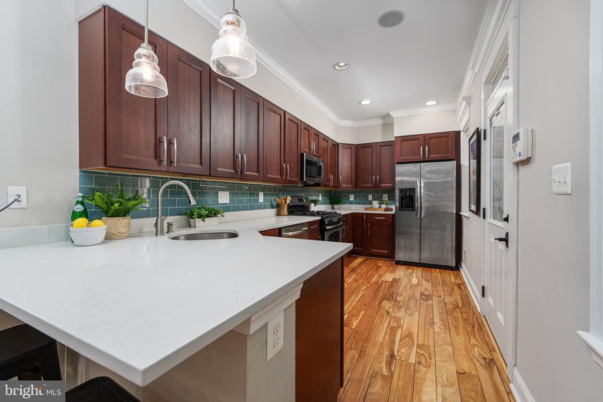 Bright and beautiful home in the epicenter of Federal Hill! This 2 bed, 2.5 bath, Building Character rehab from 2013 still looks brand new. Recent updates include paint and carpet, newly refinished floors, HVAC/heat pump condenser, bathroom renovations and a new kitchen countertop! To finish off this gem, you will find a parking pad and a rooftop deck! The basement is partially finished and would make an excellent home office. There are windows on the side of the home that add extra light to this interior townhome. 
The kitchen features a new quartz countertop and plenty of prep space along with a bar. The first floor is open and inviting for entertainment. The main level also includes a much sought after half bath.
The primary bedroom is large enough for a king and  dressers and includes an en suit, newly updated, full bathroom. There is a second, newly renovated  full bath with double shower heads  down the hall for guests. 
Panoramic views of the city are available from the expansive, rooftop deck. Finally, the parking pad has served the current owners well and they parked their SUV there!