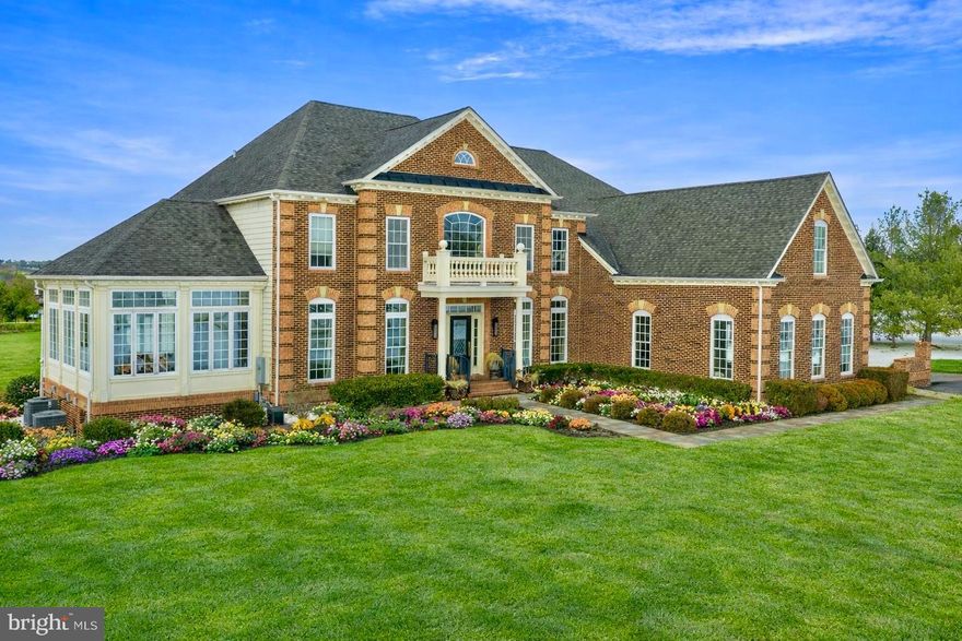 Perched gracefully on a premier corner lot, 132 Parsons Lane is a pristine 5,444-square-foot brick colonial in the heart of Newtown, PA. Thoughtfully designed and impeccably maintained, this residence blends architectural presence with refined modern comfort. A grand two-story entry sets the tone, revealing newly installed rich walnut hardwood flooring, soaring ceiling heights, and a seamless open-concept layout. Natural light pours into the conservatory just off the main hall, creating a luminous and inviting first impression.
The formal dining room transitions effortlessly into the gourmet kitchen via a well-appointed service station complete with an undercounter wine refrigerator and extensive cabinetry. The kitchen itself is both striking and functional, featuring a custom-paneled mirrored SubZero wine refrigerator, stainless steel six-burner range with hood, copper farmhouse sink, oversized marble island, dual ovens, and a spacious walk-in pantry. Whether dining beneath the crystal chandelier, gathering at the island, or entertaining on the newly installed rear deck, the space is designed for both intimate evenings and elevated hosting. The great room offers warmth and scale, anchored by a gas fireplace and a dramatic wall of windows. A private office with glass French doors, a recently updated powder room, and a well-equipped laundry room complete the main level. Upstairs, three beautifully maintained en-suite bedrooms feature newly installed custom closet systems. The Owner’s Suite is a true retreat, highlighted by tray ceiling details, soft ambient lighting, a stunning bathroom with dual vanities, a porcelain clawfoot tub, walk-in shower, and an expansive boutique-style dressing room. The fully finished lower level adds exceptional versatility with new carpeting throughout, a private gym outfitted with mirrors, and a guest bedroom and full bath with direct outdoor access—ideal for extended stays or multigenerational living. Custom brick pavers, extensive hardscaping, and manicured landscaping frame the outdoor spaces, enhancing both curb appeal and everyday enjoyment. Located within the award-winning Council Rock School District and moments from Newtown’s vibrant shopping and dining scene, this residence is just ten minutes from the river towns of New Hope and Lambertville and minutes from the beloved Wrightstown Farmers Market. A distinguished Bucks County offering, 132 Parsons Lane delivers timeless architecture, modern luxury, and an exceptional lifestyle.