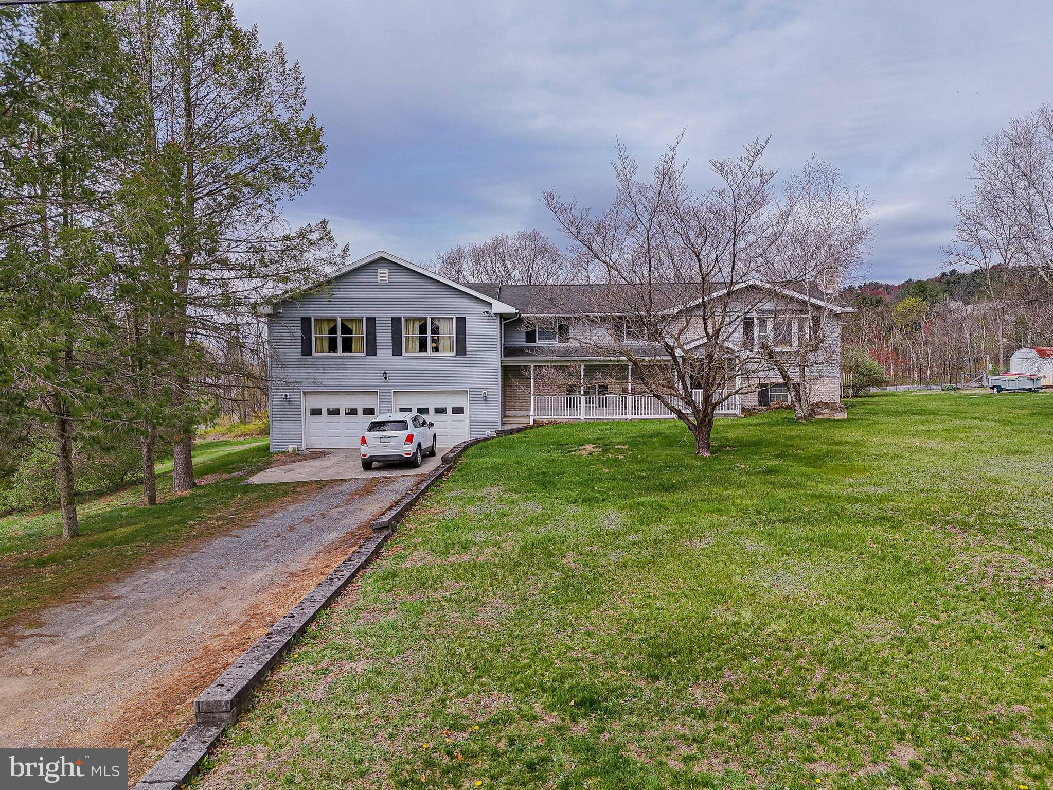 Stately East Penn Twp gem perfectly perched to capture breathtaking views of the rolling countryside & the iconic Blue Mountains. From the moment you arrive, you'll feel the charm and potential of this special property. The original area of the home, filled w/character & solid bones, is ready for your personal touch and creativity. Imagine transforming it into a cozy & timeless retreat. The dining area flows seamlessly onto a private deck-an exquisite setting for morning coffee/tea, or an evening drinks, all while immersed in the serenity of the surrounding landscape. In 2007, the home was thoughtfully expanded w/over 1,500 square feet of extra living space, including a stunning family rm w/French doors that open onto another deck-perfect for enjoying the serenity of the backyard. The generous primary bedroom suite offers a peaceful escape w/an en-suite bathroom featuring a walk-in shower. The lower level invites you to unwind in a cozy recreation rm w/a classic brick fireplace, for those chilly winter evenings. Practical convenience continues w/a laundry area/half bath, and a versatile storage room that could be easily transformed into a private office, gym, or additional living space. Car enthusiasts and hobbyists will love the expansive garage, up to six vehicles or create the ultimate workshop. Step outside from the garage onto a small patio, a charming nook to relax while enjoying nature at its finest. This home blends timeless potential w/natural beauty!