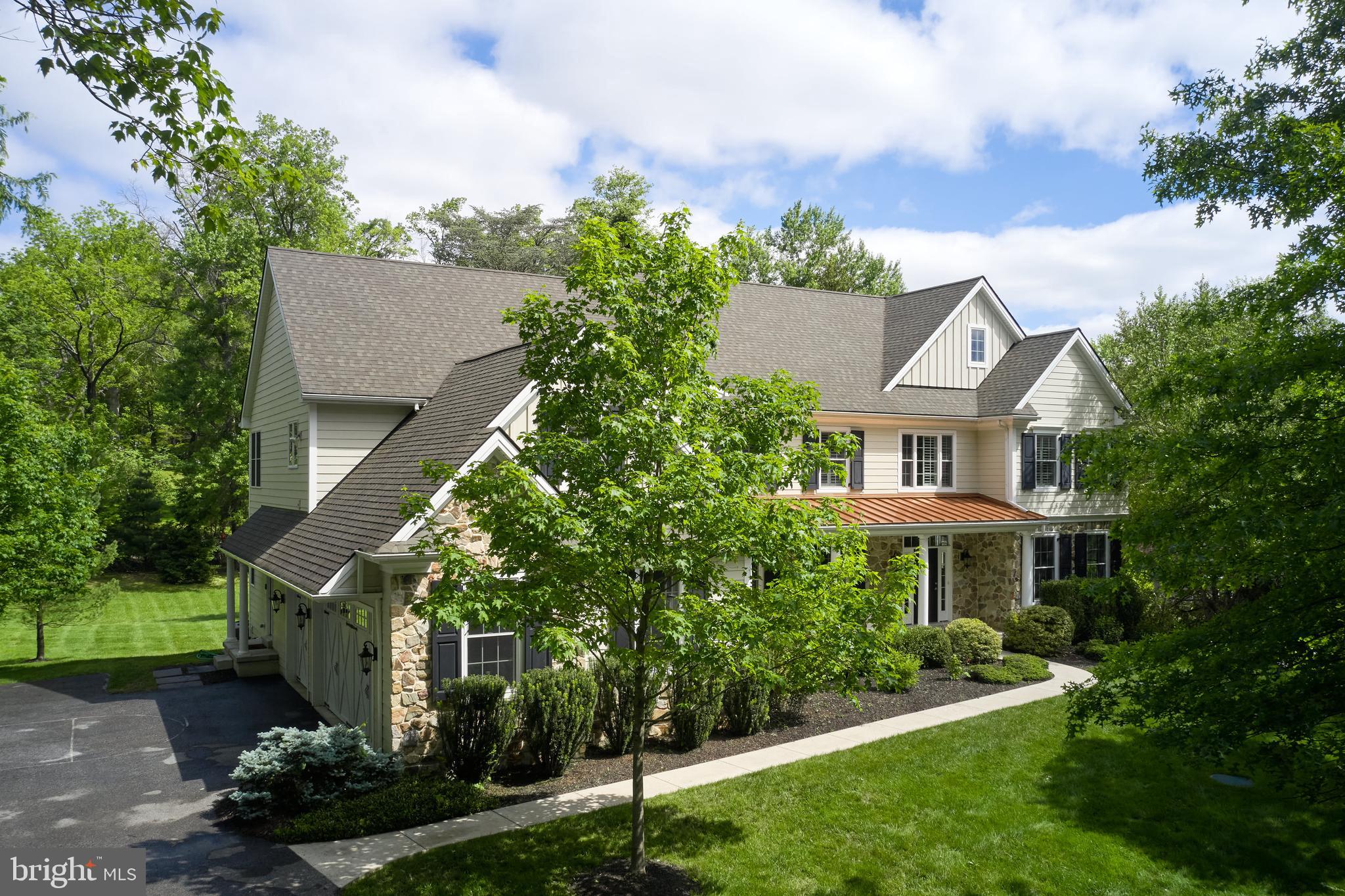 Welcome to 529 Sugartown Road, an exquisite custom home nestled in the highly sought-after Estate Section of Easttown Township. Set on over an acre of private, lush grounds, this exceptional residence offers the perfect blend of sophisticated design, modern comfort, and tranquil surroundings. Located within the prestigious Tredyffrin-Easttown School District, this 5/6 bedroom, 4 full, 2 half bath home is just minutes from Devon Yards, offering easy access to shops, dining, and public transportation, with quick routes to Philadelphia and other Main Line downtowns. The home’s striking exterior combines stone and Hardi siding, complemented by a stylish metal roof over the front porch, creating immediate curb appeal. Step inside to an expansive, sunlit two-story foyer featuring site-finished hardwood floors and custom trim work, which leads into formal living and dining rooms perfect for entertaining. A private office bathed in natural light completes the main level. The chef’s kitchen is a true standout, designed for culinary enthusiasts with an oversized island, high-end stainless steel appliances, double oven, gas range, custom cabinetry (including glass-front displays), a walk-in pantry, and a butler’s pantry. Under-cabinet lighting adds to the ambiance. The open layout seamlessly flows into a spacious family room with a wood burning fireplace, highlighted by a wall of windows that fill the space with views of the private back yard, and the adjacent breakfast room offers easy access to the expansive Trex deck. The deck overlooks beautifully landscaped grounds and a sprawling private backyard, ideal for outdoor living and gatherings. Upstairs, the luxurious owner’s suite is a true retreat, offering tray ceilings, recessed lighting, a private sitting room, dual walk-in closets, and a spa-like en suite bathroom with premium finishes. The second-floor features four additional sun-filled bedrooms sharing two Jack and Jill bathrooms, along with a dedicated laundry room for added convenience. The home also includes a large mudroom with built-in storage and access to 3 car attached garage, two powder rooms, custom closets throughout, and a back staircase for additional functionality. The recently finished walk-out basement provides a wealth of recreational space, including a game room, a home gym, wet bar, a full bath, and a theater room that can also serve as a 6th bedroom/nanny suite/in-law suite, offering endless possibilities for family enjoyment and relaxation. For peace of mind, the home is equipped with a generator with wiring and switch set up, ensuring you’ll never be without power during storms or outages. Located in a prime area for both privacy and convenience, 529 Sugartown Road offers the tranquility of country living with the benefits of Main Line amenities. This home presents a rare opportunity to own in one of the most desirable areas on the Main Line just a short ride to the R5 train, Public Library, shopping and fine dining in Devon Square, the King Of Prussia Mall/Town Center, Wayne and Berwyn, and convenient to state roads, public transportation and the best public and private schools in the country. Schedule a private showing today to experience everything this stunning home has to offer.