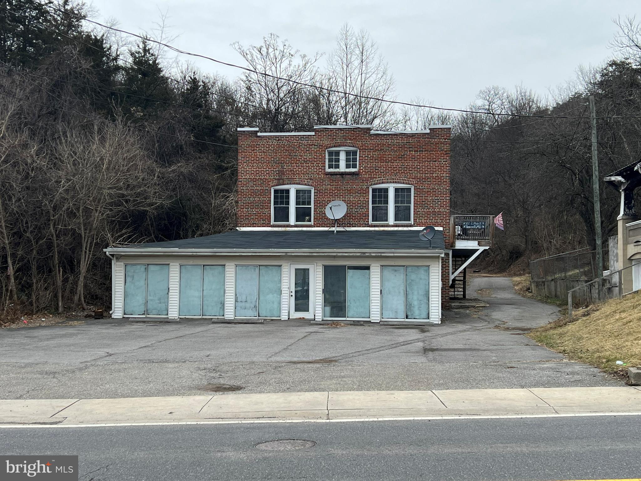 This unique brick property offers a three-bedroom, one-bathroom home with a garage underneath that was previously converted into an antique store, providing potential for a variety of uses. A large parking lot offers ample space for residents, customers, or future expansion. At the rear of the home, a spacious metal garage with its own dedicated electric service is connected to the house by an enclosed walkway, adding convenience and functionality. Located along Main Street, this property is just a stone’s throw from the Western Maryland Rail Trail and within close proximity to shopping, the C&O Canal, and the Potomac River boat launch. With its prime location and versatile spaces, this property presents a great opportunity for a home, business, or investment.