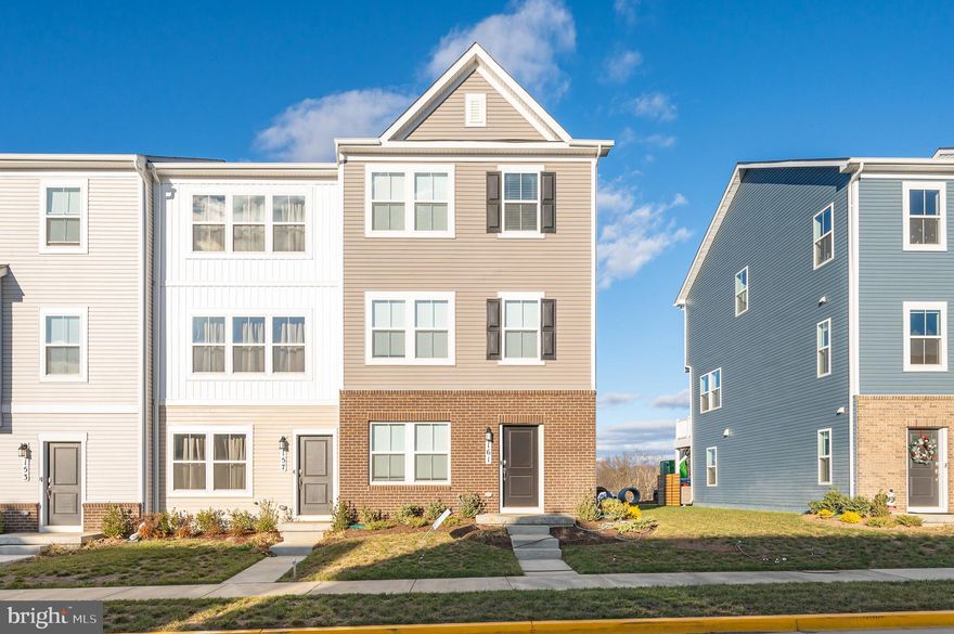 This end unit townhome features three levels of immaculate living space. You also have a TWO car garage, nearly unheard of in a townhome! The lower level of the home features LVP flooring in the spacious family room and powder room. The main level features an open floor plan with LVP floors throughout. The large family room has lots of windows for tons of natural light. The ceiling fan light fixture keeps the space airy. There is a convenient half bath in this space with a pedestal sink. The living room is open to the kitchen and dining room. This is a great set up if you like to entertain. In the kitchen have classic finishes with white shaker cabinets, granite countertops, and a white subway tile backsplash. The huge island provides extra prep and storage space along with breakfast bar seating for up to four. Beyond the island you have a spacious dining room with overhead lighting. This space also features access to your large rear deck. This is the perfect space for Summer BBQs or just enjoying the sunshine in warmer months. The upper level of the home features a carpeted hallway with a convenient laundry closet. This keeps your machines nicely tucked away and provides ample storage. Down the hall you have two generously sized bedrooms featuring carpet, large closets, and overhead lighting. The hall bath features a white shaker single bowl vanity and 5 ft tub/shower with tile surround. The primary suite features carpet, ceiling fan, and recessed lighting. The private ensuite includes LVP floors, double bowl shaker cabinet vanity, and a 4 ft should with tile surround and bench seat. The suite is completed by a walk-in closet.  You will want for nothing in this beautiful home. Schedule your showing today!