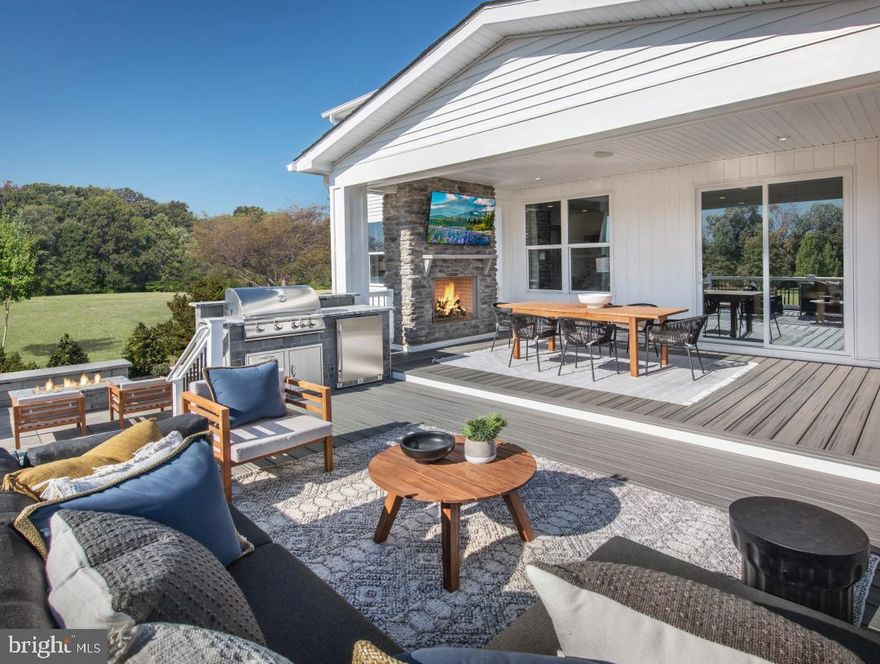 LAST HOME - PICKERING MODEL now for sale! The professionally decorated model comes with custom painting, window treatments, decorative features, and upgrades throughout. 
The welcoming foyer with a tray ceiling is open to a spacious front flex room and expansive great room beyond.  A chef's dream kitchen awaits with large center island, upgraded cabinets, custom countertops, solid quartz backsplash, and upgraded appliances. The walk-in pantry with built-in shelving offers an enormous amount of storage.  The sun drenched causal dining room opens right into the great room. Perfect for entertaining the great room includes upgraded flooring, built-ins and a floor to ceiling slate tiled fireplace. Completing the 1st floor is a conveniently located guest bedroom and full bath with walk-in shower.  This space has upgraded flooring , custom decorative herringbone wall panels and luxury bathroom tile. 
Travel up the open concept oak stairs to the spacious sun lite loft. Go from the generous loft to one of three secondary bedrooms—two with a shared bath, one with a shared hall bath. This second floor has an oversized laundry room with a full wall of cabinets and a large vanity. Washer and dryer are included. Highlighting the 2nd floor is the magnificent primary bedroom suite with tray ceiling, pendants and window treatments.  An impressive primary bath with custom tile, quartz dual vanities, a expanded luxe shower with seat, and linen closet storage. The large walk-in closet has adjustable built-in shelving and drawers.  
Entertain in the finished lower level that boasts a bar and plenty of additional living space.  Powder room and 2 storage spaces complete the basement. 
The backyard retreat is perfect for year round living. The outdoor living space is complete with an outdoor fireplace, custom built-in grill with fridge, multi deck level, a patio, and a fire pit. This must see outdoor space will have all your friends talking.