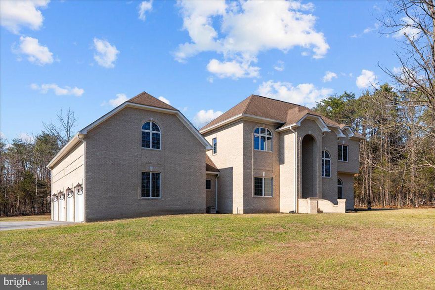 This all-brick custom home sits on 8 acres on the east side of Winchester, offering a prime commuter location with a gated entrance for added privacy. The main level includes a high-end kitchen with a gas cooktop, double wall ovens, and a large pantry, alongside a family room with a fireplace and wet bar. An additional room on this level serves as an optional living room or office, while covered porches on both the main and second floors provide ample outdoor living space.
The second level features a primary suite with a gas fireplace, private covered porch, walk-in closet with custom built-ins, and an en-suite bathroom with a soaking tub and walk-in shower. The second bedroom includes its own private bathroom, while the third and fourth bedrooms are connected by a Jack and Jill bathroom. For automotive storage, the property offers a four-car garage with a large unfinished loft ready for future conversion.
Built for efficiency, the home features a three-zone HVAC system and Superior brand basement foundation walls. The basement includes a wood stove and French door outside access, providing a clean slate for additional finished living space. Professional photos coming 3/11/26