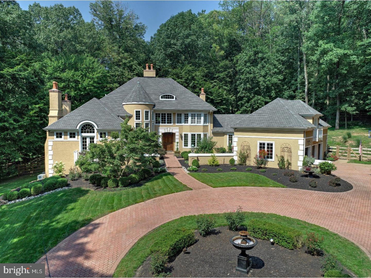 Spectacular Gated French Country Estate on 5.01 acres in Upper Makefield. This beautifully updated home features antique light fixtures by David John Metal Artisan. As you enter the gate the long landscaped drive leads you to a Circular Driveway w/newly landscaped courtyard w/2 additional antique light fixtures. Enter the home through an oversized wood door into grand 2 story foyer w/marble flrs and a quartz stone wall. Step down into the 2 story great rm w/HW, a bay of floor to ceiling windows, wet bar w/Sub Zero, French doors leading to patio & a 2 story quartz stone FP. Flanking the Great Room is an office w/HW, coffered ceiling and built-in bookcases by William Draper, and plus a garden room w/HW, FP, marble mantle and French doors leading to patio. Surround sound speakers t/o 1st floor. The master suite is located on the main level and features HW flrs, wood burning FP, French Doors to balcony, his/her walk-in closets & his/her bathrooms. Walk through the gallery with a window seat and view of the courtyard to formal DR, kitchen and breakfast room. This kitchen is a cooks dream. Every amenity imaginable is here, 2 Miele DW's, Wolf Double Ovens, Wolf Warming Drawer, Kitchen Aid Trash Compactor, Miele Coffee Station, Wolf Steamer, Diva Induction Cooktop w/ pot filler, Double Sub Zero refrigerator w/ 4 Sub Zero Freezer Drawers & Sharp Microwave Drawer. Custom cabinetry including wall of built in panty units with flip out shelves, center island, 3 inch thick granite counter tops, Copper Farm Sink, Copper Prep Sink and Limestone floors which continue into the breakfast rm that contains 3 walls of windows and French Doors leading out to the patio. In-Law/Nanny Suite w/ separate entrance is found above the 3 car garage and features an en suite bath, 2 walk-in closets and French Doors leading to Juliet balcony. Take the stairs in the turret upstairs where you find 3 additional BRs and two baths. One BR has an en suite, 2nd BR is a bunk room that all will love and the 3rd BR features a large bay of windows w/ plantation shutters. New Masland Carpets & runner in these BRs w/ HW flrs in stair new HW flrs in hallway & catwalk. Downstairs is an additional 1600 square foot amazing finished walk-out basement which features Limestone FP w/gas logs, William Draper built theater rm, billiard rm & 2nd office, bar & limestone moldings! Whole house generator! Award winning Council Rock School District. Convenient to I95, NYC trains and Princeton.