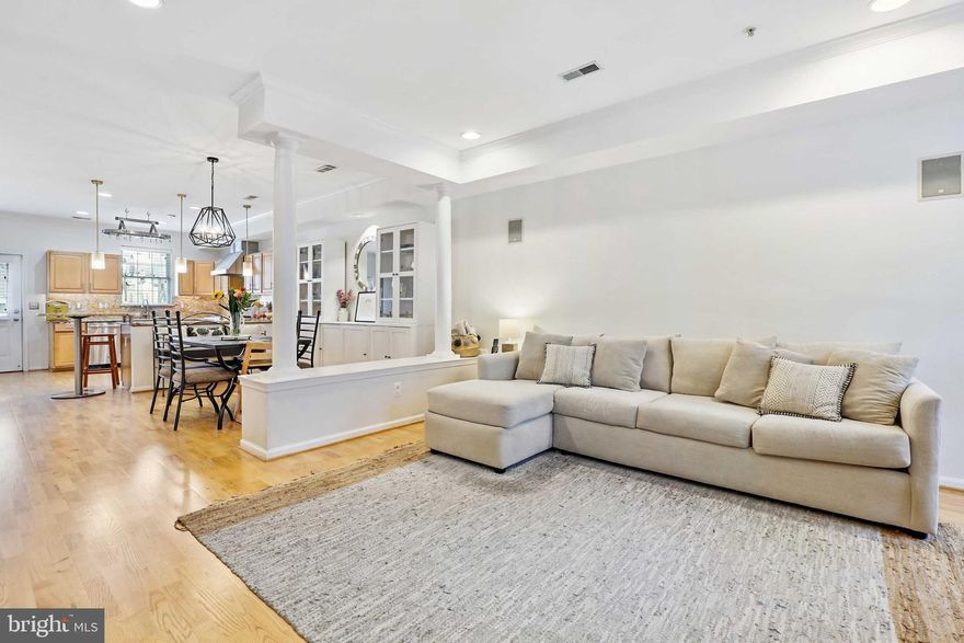 Stunning 3 bedroom, 2.5 bath end unit in Locust Point with 2 car parking pad! The entry level features an open floor plan with hardwood floors, chair rail, crown molding, recessed and contemporary lighting, first floor half bath and a very spacious living and dining room area with high ceilings and great natural light . Gourmet custom kitchen with granite counters, Wolf gas range with exhaust hood, built-in microwave, stainless steel appliances and generous sized pantry. The second level, also featuring hardwood floors throughout,  includes a fabulous primary bedroom with tray ceiling and ceiling fan, an en suite bath,newly renovated two-person double shower with gorgeous herringbone tiling,  double vanity and a huge custom walk-in closet! Second bedroom with custom shutters makes a great bedroom, office or nursery (you may recognize this beautiful space from its design feature in Baltimore magazine!).  The spacious upper level includes the third bedroom with wall-to-wall closeting and tons of bonus storage with a full bath and a family room area with built-in wet bar. From there, step outside to enjoy an incredible, two-tier outdoor space! The first level is perfect for dining, relaxing, or setting up a kids' playspace, while the oversized rooftop deck offers skyline views of the harbor and direct access to gas for grilling out. Situated on a quiet street, the home's prime location positions you just blocks away from beautiful water views at Fort McHenry, family and pet-friendly amenities of Latrobe Park, and the beautiful boardwalk and convenient Water Taxi located at Under Armour. This bright, spacious home has been meticulously maintained and is a must-see!