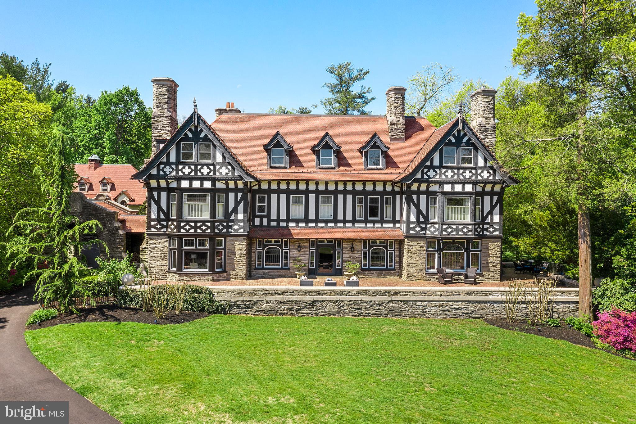 Introducing one of the last great estates in Radnor Township. Thornhedge is a magnificent Elizabethan style stone Tudor home sitting on 2.576 acres. This home has a commanding presence in one of the Main Line's most sought after communities, maintaining a type of elegance attributed to that special time in the early 20th Century found throughout the first level. The Grand Front Entry invites one to inspect the architectural intricacies of a bygone era. Breathtaking moldings include, one of a kind quarter sawn oak and mahogany walls and moulded plaster ceilings. The attention to detail with old-world craftsmanship, rich millwork, and arched doors, is something rarely found in a home and creates a unique opportunity for the Buyer of today. The Study, Library, and Living Room are graced with the original leaded glass windows designed to bring in volumes of light accented with classic deep windowsills. A large Country Kitchen is complete with stainless steel appliances, center island, walk-in pantry, back stairway and a Laundry/Mud Room. An adjacent Butlers Pantry joins the family space to the Formal Dining Room making it ideal for entertaining. Fireplaces, accenting the warmth of the home, are found throughout the First Floor. The transverse Grand Staircase leads to a landing with over-sized intricately designed, leaded glass windows allowing streams of light to descend upon the 1st Floor. On the Second level you will find an elegant Master Suite with a fireside Bedroom newly renovated Bath, Sitting Room with a marble fireplace and large walk-in closet/dressing area. Additionally, there are 2 Bedrooms sharing a brand new Jack and Jill bath and 1 bedroom with a Hall Bath. The former servant's wing (bedrooms) were transformed into individual areas and work from home office creating a distraction free, dedicated space for everyone at home without infringing on bedrooms or common living spaces. The 3rd Floor is equipped with 3 Bedrooms, a Billiard Room with fireplace, 2 Full Baths, a Work-Out Room, and an Entertainment Area among other unique spaces. Delight in the outdoors with a beautiful limestone patio overlooking a private pool and courtyard. Mature landscaping and a built-in barbecue invite you to relax and enjoy the Spring, Summer and early Fall seasons. This 1903 mansion designed by Edgar V. Seller has it all. We are looking for the next family to be stewards of this magnificent 8500 square foot home. With a one of kind masterpiece house, top ranked school district, and prime location to town, this estate has everything you could imagine and more. In addition to the main house there is a separately deeded carriage home for sale as well with its own entrance and exit on Chamounix Circle. The carriage home has a wood shop, a large storage area and a 2/3 bedroom apartment on top with a full kitchen and bathroom. The carriage home is 3,220 square feet with an attached garage that can fit 3 cars and includes a built in Telsa charger. The carriage home has been rented in the past for 1,500/2,000 a month. The carriage home is being sold "As Is". Total taxes for the main home and the carriage home is $40,286. Total acreage for the main home and the carriage home is 2.576. Please note that Delaware County is conducting a real estate tax reassessment, effective January 1, 2021. If you have any questions or concerns about the impact of this process on the future real estate taxes for this property, you should contact the Delaware County Treasurer's Office or call the Tax Reassessment Hotline at 610-891-5695.
