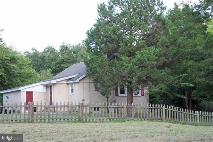 Affordable privacy with close to town convenience. Beautiful 2.7 acre lot that is so private and secluded but its 3 miles from downtown! Drive down your deeded private lane to this charming bungalow perched on a high lot surrounded by trees. Pergo floored kitchen, cute sunroom, partial basement, large bedrooms. Huge cleared lot with potential for adding a garage, pole building. Sold as is.