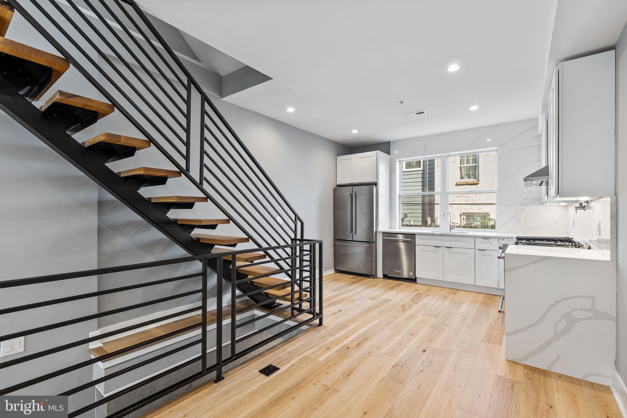 Introducing 2227 League Street! This modern row home impresses immediately. Enter to hardwood floors, soaring ceilings, and a raised kitchen and dining area that creates delineated spaces for living and dining. Upgraded kitchen with white shaker cabinets, stainless appliances, and quartz backsplash to compliment the countertop. Range hood over the oven. Microwave built-in to the cabinet. Floating stairs rise to the second level with two amply apportioned bedrooms bifurcated by a full bath with shower/tub. Tastefully modern bathroom fixtures and vanity. Of course, the challenge in every Philadelphia row home is bringing natural light from the front and back into the heart of the home. This home addresses that challenge with glass enclosed stairwells on the second and third floor. Even better, an upgraded kitchenette wet bar awaits at the top of the third floor landing. Perfect for entertaining on the roof deck. Even better for the coffee pot as it's conveniently situated outside the primary bedroom suite. Impressive primary bedroom with ample natural light, custom closets sufficient for most, and an upgraded bathroom with double, floating vanity, soaking tub, and spa-like shower. Roof deck offers unobstructed Center City views. Don't miss the daylighted basement with large windows creating a cozy den. Private, full bath in basement for convenience of main level guests as well. Enjoy Graduate Hospital living here. A short walk to all the neighborhood amenities. +++ Property tax abatement appeal GRANTED. According to abatement attorney, once abatement has been processed, abatement period will be 11/1/2022 - 10/31/2032. See attached correspondence from City of Philadelphia regarding abatement.