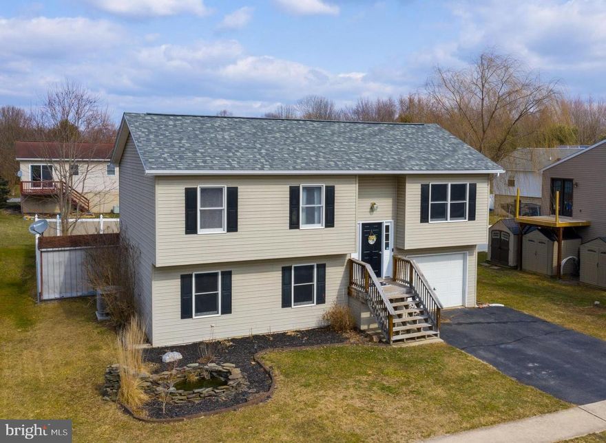 Located on a cul-de-sac in Northeastern School District is where you will find this 3 bedroom, 2 full bath split foyer home featuring an awesome fenced in back yard!!  New roof installed in 2019 with a 30 year transferable warranty is a plus! Nice kitchen with center island, breakfast bar and all appliances. Directly located off of the kitchen is the dining room with a door leading out to the rear deck. Large living room featuring new carpet! Three nice sized bedrooms can also be found on the main level along with a full bath. As you journey downstairs you will be greeted by a spacious family room with wet bar and full bath. This is the ideal spot to entertain!! Just in time for summer fun, enjoy relaxing and making s'mores around the beautiful fire pit area. Decorative fish pond with waterfall feature, attached one car garage and storage shed. Open main level layout makes entertaining a breeze. Schedule your private tour today before the SOLD sign goes up!