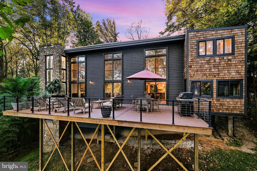 OVER $100K PRICE DROP!  

MAGNIFICENTLY RENOVATED, ONE OF A KIND Mid-Century Modern Home with 5 bedrooms (the 6th currently used as an exercise room), 5½ bathrooms – all done over the past two years. Nestled onto the hillside, you have a private view at the back of the home that overlooks the North Branch Trail. The two-story picture windows with three sliding glass doors provide access to the new deck. The views from the mezzanine on the top floor also boast peaceful and breathtaking views.

When you enter the home from the main floor, the welcoming foyer will lead you to a beautifully redesigned chef’s kitchen. All the appliances throughout the home are top-of-the-line.  This exquisite kitchen with porcelain, backsplash, countertops and 30 sq. ft. prep island features a Wolf six burner stove plus griddle and double oven, Wolf Built-in Microwave, two Cove dishwashers, and Sub-Zero window-in-door refrigerator/freezer. Flowing directly into the spacious beautiful dining room and large deck, the layout is perfect for entertaining.  The adjacent living room with fireplace is also easily accessible on this open floor plan. The study/den/office off of the living room has built in floor to ceiling cabinets – plenty of space to work and study.  The living area also has a unique renovated spiral staircase, original to the home, that leads to the upstairs mezzanine and bedrooms.

Off the other side of the kitchen is a coffee/cocktail lounge with a beverage bar, large walk-in pantry, and cozy seating area.  The Wolf window-in-door beverage refrigerator is topped with the same beautiful porcelain countertop in the kitchen and has beautiful upper cabinetry and drawers below. The seating area in the lounge has access to the deck and the large pantry has cabinetry and room for a second refrigerator or more storage.

On the top floor there are three bedrooms – the owner’s suite, a second primary bedroom, and a guest bedroom that can easily be transformed into the perfect nursery or office. Each have their own full bathroom and the second laundry room is conveniently located on this floor. The owner’s suite has a fireplace, a beautiful bathroom, a giant walk-in-closet and ample room for a sitting area.  The owner’s suite also has a private rooftop terrace - where you can enjoy a quiet cup of morning coffee or an evening cocktail. 

The lower level of this home has a self-contained suite with its own outside entrance, bedroom, full bathroom, living room, and kitchen – with access to a lower floor laundry room (including new washer and dryer), an additional full bath and bedroom/ exercise room. You will notice the lower level does not feel like a basement because it is situated on the hillside - each room has full windows with views of the surrounding trees.   

Make sure to take your time exploring this stunning home and you will fall in love with its extensive features.

NOTE: The square footage is measured at 6,092 sq. ft (see floor plans).
LISTING AGENT IS UNAVAILABLE THROUGH SATURDAY )CTOBER 26.  I WILL RESPOND TO ALL MESSAGES AS SOON AS POSSIBLE