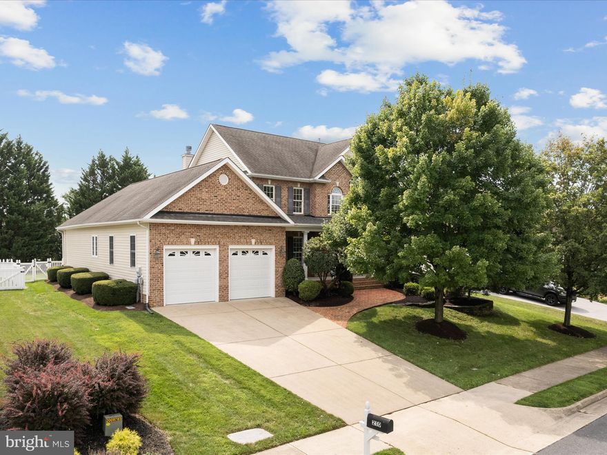 This stately home in established Ravenwing offers nearly 3,000 square feet of finished living space. As you approach the home, mature landscaping surrounds a lovely brick walkway and covered front porch. The front door shines with transom and side lights, opening to a warm foyer, gleaming hardwood floors, arched doorways and custom trim.  The foyer is flanked by a formal dining room and living room/library, all with special finishing details.  The hardwoods continue to the open family room and gourmet kitchen. The heart of the family room is a floor to ceiling stone fireplace with hearth and custom mantle. The kitchen offers a large island, granite countertops, double ovens and generous counterspace.  Just off the kitchen, sliding doors open to the fenced back yard with a rear covered deck and inground, fiberglass, saltwater, heated pool with tasteful hardscaping.  Also found on the main floor are 9' ceilings, a walk in laundry room, power room and the first of two primary suites showcasing a tray ceiling, walk in closet, and deluxe bath with tub, separate shower and dual vanities.  Upstairs includes a second primary suite with walk in closet, two additional bedrooms, a full bathroom and lovely reading nook. Homes provides room to grow with an unfinished walk up basement. Irrigation system installed.  Constructed by local custom builder Tom Mannarino.