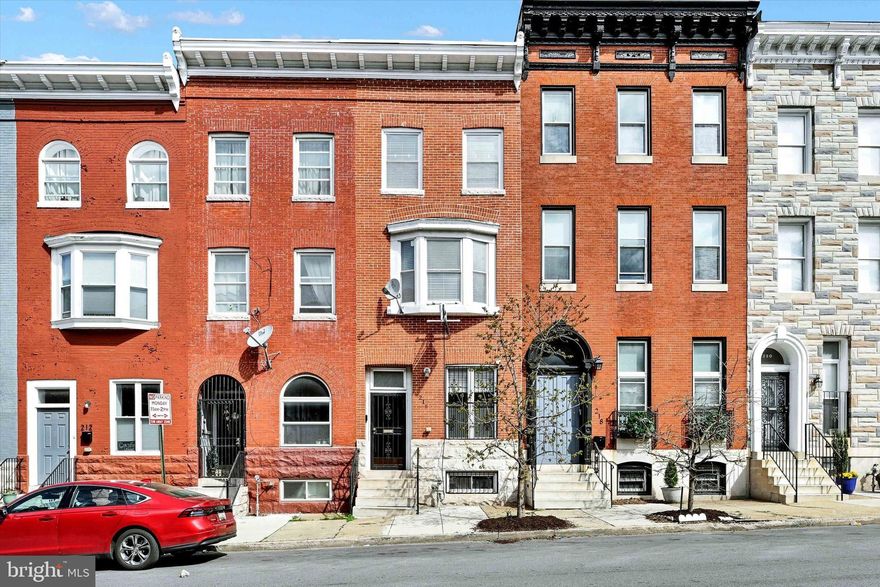 Style and convenience unite in this beautifully renovated four level home in Greenmount West. Exposed brick and hardwood floors greet you as you enter the open concept first floor complete with high ceilings, stainless steel appliances, granite countertop, a half bath and an attached climate controlled garage (or flex space). Up one level, you’ll find a cozy primary suite with a spacious bathroom, separate jetted tub and shower, dual vanities and balcony as well as a light filled family room and convenient laundry room. The top level contains two additional bedrooms and full hallway bathroom with dual vanities. Sliding doors open to a raised deck that overlooks all of northern Baltimore City. The basement is primed for additional finished space with a rough-in for another bathroom. Out back, you’ll find a gated parking pad for recreation or additional parking. The house backs to the 3/4 acre Hidden Harvest Farm, an urban community garden/green space. Updates include a two zone HVAC system, modified Bitumen roof system and composite Fiberon roof deck. Enjoy prime city living with Penn Station and University of Baltimore just a short walk away along with restaurants, cafes, bars, theaters, cultural attractions and so much more.