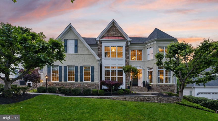 Premium Lansdowne Living on Goose Creek. Positioned at the end of a cul-de-sac on one of the most coveted streets of Lansdowne on the Potomac, this sought-after Van Metre Knoll model sits on a third-acre lot backing to mature tree privacy and the creek itself, with west-facing sunsets off the back of the home and a private pathway leading from the yard down to hiking trails and a canoe and kayak launch. Enjoy a four-car garage, grand-scale rooms, and designer-level updates throughout. Inside, a two-story foyer opens to sweeping stairs, a private home office, and a sunlit formal living room. The adjoining formal dining room offers flexibility for entertaining or everyday use, with elegant moldings, updated lighting, and a flowing floor plan that carries through the main level. An updated butler’s pantry leads into a fully renovated chef’s kitchen, showcasing gleaming white cabinetry and countertops, quality stainless appliances, abundant storage, and a generous island built for casual meals and conversation. The vaulted sunroom just beyond opens directly to the deck for an easy indoor-outdoor flow, with wooded views in every direction. The family room continues the open layout, with a fireplace and three soaring arch-topped windows. Two updated powder baths sit conveniently near the front entry and mudroom. Upstairs, rich hardwoods give way to new carpet in the private quarters. The primary suite occupies its own private wing with tray ceilings, a sitting area, dual walk-in closets, and a spa-style bath featuring a jetted soaking tub, passthrough shower, and double vanities. An adjoining bedroom works beautifully as a nursery, office, or yoga space and connects through a Jack-and-Jill bath to a third bedroom. Two more upper bedrooms share their own updated Jack-and-Jill bath. The lower level walks out to the patio and features a gorgeous renovated rec room with high-end LVP chevron flooring, designer lighting, and a fully equipped bar. This level also hosts a home theater room, a bonus room, a full bath, and a large bedroom with walk-in closet and full windows for a true guest or multigenerational suite. Outside, the fenced backyard offers multiple patio spaces, a covered area for shade, and a fire pit, all set against a lawn that backs into the trees. The expansive deck off the main level is built for grilling and gathering above the canopy. Recent improvements include the remodeled kitchen (2023), full basement renovation and new water heater and sump pump (2021), new HVAC with warranty through 2029 (2024), reimagined outdoor spaces with new deck, patio, fence, fire pit, and walkway stairs (2022), main-level flooring, mudroom built-ins, and basement media room (2017), washer and dryer (2020), dishwasher (2021), yard irrigation, refreshed bathrooms with new paint, lighting, sinks, hardware, and toilets, custom light fixtures throughout, and over twenty newly planted trees with custom flower beds. Lansdowne amenities include indoor and outdoor pools, a fitness center, playgrounds, sport courts, aerobics rooms, a ballroom, business center, and more, with Riverside High, Belmont Middle, the community playground, and tennis and pickleball courts all close by. Route 7, Lansdowne Town Center, the Golf Club at Lansdowne, Lansdowne Resort and Spa, One Loudoun, and Bazil Newman Riverfront Park are all within easy reach. A rare combination of privacy, scale, and a very special location, in one of Northern Virginia’s most distinguished communities.