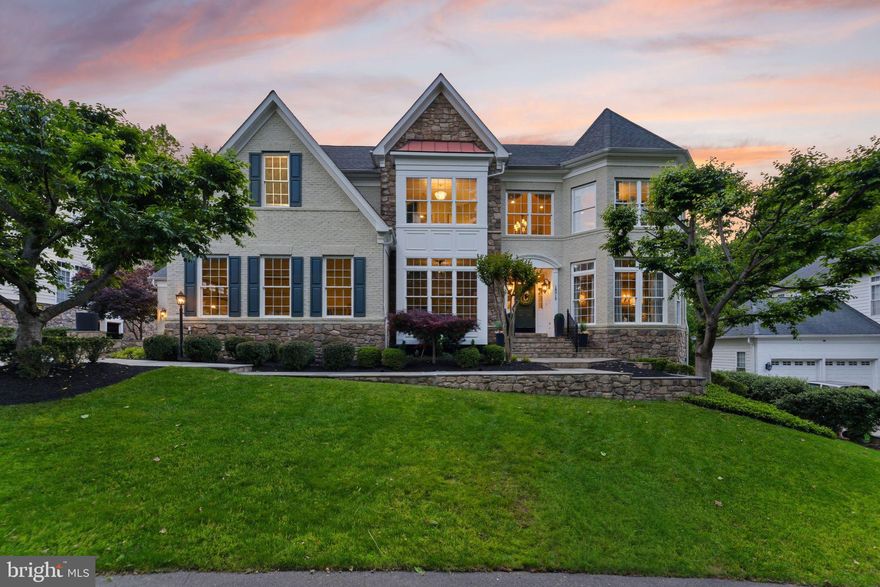 Premium Lansdowne Living on Goose Creek. Positioned at the end of a cul-de-sac on one of the most coveted streets of Lansdowne on the Potomac, this sought-after Van Metre Knoll model sits on a third-acre lot backing to mature tree privacy and the creek itself, with west-facing sunsets off the back of the home and a private pathway leading from the yard down to hiking trails and a canoe and kayak launch. Enjoy a four-car garage, grand-scale rooms, and designer-level updates throughout. Inside, a two-story foyer opens to sweeping stairs, a private home office, and a sunlit formal living room. The adjoining formal dining room offers flexibility for entertaining or everyday use, with elegant moldings, updated lighting, and a flowing floor plan that carries through the main level. An updated butler’s pantry leads into a fully renovated chef’s kitchen, showcasing gleaming white cabinetry and countertops, quality stainless appliances, abundant storage, and a generous island built for casual meals and conversation. The vaulted sunroom just beyond opens directly to the deck for an easy indoor-outdoor flow, with wooded views in every direction. The family room continues the open layout, with a fireplace and three soaring arch-topped windows. Two updated powder baths sit conveniently near the front entry and mudroom. Upstairs, rich hardwoods give way to new carpet in the private quarters. The primary suite occupies its own private wing with tray ceilings, a sitting area, dual walk-in closets, and a spa-style bath featuring a jetted soaking tub, passthrough shower, and double vanities. An adjoining bedroom works beautifully as a nursery, office, or yoga space and connects through a Jack-and-Jill bath to a third bedroom. Two more upper bedrooms share their own updated Jack-and-Jill bath. The lower level walks out to the patio and features a gorgeous renovated rec room with high-end LVP chevron flooring, designer lighting, and a fully equipped bar. This level also hosts a home theater room, a bonus room, a full bath, and a large bedroom with walk-in closet and full windows for a true guest or multigenerational suite. Outside, the fenced backyard offers multiple patio spaces, a covered area for shade, and a fire pit, all set against a lawn that backs into the trees. The expansive deck off the main level is built for grilling and gathering above the canopy. Recent improvements include the remodeled kitchen (2023), full basement renovation and new water heater and sump pump (2021), new HVAC with warranty through 2029 (2024), reimagined outdoor spaces with new deck, patio, fence, fire pit, and walkway stairs (2022), main-level flooring, mudroom built-ins, and basement media room (2017), washer and dryer (2020), dishwasher (2021), yard irrigation, refreshed bathrooms with new paint, lighting, sinks, hardware, and toilets, custom light fixtures throughout, and over twenty newly planted trees with custom flower beds. Lansdowne amenities include indoor and outdoor pools, a fitness center, playgrounds, sport courts, aerobics rooms, a ballroom, business center, and more, with Riverside High, Belmont Middle, the community playground, and tennis and pickleball courts all close by. Route 7, Lansdowne Town Center, the Golf Club at Lansdowne, Lansdowne Resort and Spa, One Loudoun, and Bazil Newman Riverfront Park are all within easy reach. A rare combination of privacy, scale, and a very special location, in one of Northern Virginia’s most distinguished communities.