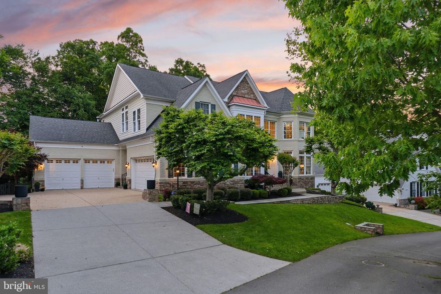 Premium Lansdowne Living on Goose Creek. Positioned at the end of a cul-de-sac on one of the most coveted streets of Lansdowne on the Potomac, this sought-after Van Metre Knoll model sits on a third-acre lot backing to mature tree privacy and the creek itself, with west-facing sunsets off the back of the home and a private pathway leading from the yard down to hiking trails and a canoe and kayak launch. Enjoy a four-car garage, grand-scale rooms, and designer-level updates throughout. Inside, a two-story foyer opens to sweeping stairs, a private home office, and a sunlit formal living room. The adjoining formal dining room offers flexibility for entertaining or everyday use, with elegant moldings, updated lighting, and a flowing floor plan that carries through the main level. An updated butler’s pantry leads into a fully renovated chef’s kitchen, showcasing gleaming white cabinetry and countertops, quality stainless appliances, abundant storage, and a generous island built for casual meals and conversation. The vaulted sunroom just beyond opens directly to the deck for an easy indoor-outdoor flow, with wooded views in every direction. The family room continues the open layout, with a fireplace and three soaring arch-topped windows. Two updated powder baths sit conveniently near the front entry and mudroom. Upstairs, rich hardwoods give way to new carpet in the private quarters. The primary suite occupies its own private wing with tray ceilings, a sitting area, dual walk-in closets, and a spa-style bath featuring a jetted soaking tub, passthrough shower, and double vanities. An adjoining bedroom works beautifully as a nursery, office, or yoga space and connects through a Jack-and-Jill bath to a third bedroom. Two more upper bedrooms share their own updated Jack-and-Jill bath. The lower level walks out to the patio and features a gorgeous renovated rec room with high-end LVP chevron flooring, designer lighting, and a fully equipped bar. This level also hosts a home theater room, a bonus room, a full bath, and a large bedroom with walk-in closet and full windows for a true guest or multigenerational suite. Outside, the fenced backyard offers multiple patio spaces, a covered area for shade, and a fire pit, all set against a lawn that backs into the trees. The expansive deck off the main level is built for grilling and gathering above the canopy. Recent improvements include the remodeled kitchen (2023), full basement renovation and new water heater and sump pump (2021), new HVAC with warranty through 2029 (2024), reimagined outdoor spaces with new deck, patio, fence, fire pit, and walkway stairs (2022), main-level flooring, mudroom built-ins, and basement media room (2017), washer and dryer (2020), dishwasher (2021), yard irrigation, refreshed bathrooms with new paint, lighting, sinks, hardware, and toilets, custom light fixtures throughout, and over twenty newly planted trees with custom flower beds. Lansdowne amenities include indoor and outdoor pools, a fitness center, playgrounds, sport courts, aerobics rooms, a ballroom, business center, and more, with Riverside High, Belmont Middle, the community playground, and tennis and pickleball courts all close by. Route 7, Lansdowne Town Center, the Golf Club at Lansdowne, Lansdowne Resort and Spa, One Loudoun, and Bazil Newman Riverfront Park are all within easy reach. A rare combination of privacy, scale, and a very special location, in one of Northern Virginia’s most distinguished communities.