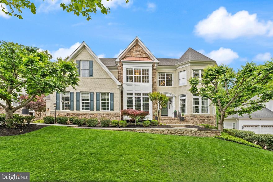 Premium Lansdowne Living on Goose Creek. Positioned at the end of a cul-de-sac on one of the most coveted streets of Lansdowne on the Potomac, this sought-after Van Metre Knoll model sits on a third-acre lot backing to mature tree privacy and the creek itself, with west-facing sunsets off the back of the home and a private pathway leading from the yard down to hiking trails and a canoe and kayak launch. Enjoy a four-car garage, grand-scale rooms, and designer-level updates throughout. Inside, a two-story foyer opens to sweeping stairs, a private home office, and a sunlit formal living room. The adjoining formal dining room offers flexibility for entertaining or everyday use, with elegant moldings, updated lighting, and a flowing floor plan that carries through the main level. An updated butler’s pantry leads into a fully renovated chef’s kitchen, showcasing gleaming white cabinetry and countertops, quality stainless appliances, abundant storage, and a generous island built for casual meals and conversation. The vaulted sunroom just beyond opens directly to the deck for an easy indoor-outdoor flow, with wooded views in every direction. The family room continues the open layout, with a fireplace and three soaring arch-topped windows. Two updated powder baths sit conveniently near the front entry and mudroom. Upstairs, rich hardwoods give way to new carpet in the private quarters. The primary suite occupies its own private wing with tray ceilings, a sitting area, dual walk-in closets, and a spa-style bath featuring a jetted soaking tub, passthrough shower, and double vanities. An adjoining bedroom works beautifully as a nursery, office, or yoga space and connects through a Jack-and-Jill bath to a third bedroom. Two more upper bedrooms share their own updated Jack-and-Jill bath. The lower level walks out to the patio and features a gorgeous renovated rec room with high-end LVP chevron flooring, designer lighting, and a fully equipped bar. This level also hosts a home theater room, a bonus room, a full bath, and a large bedroom with walk-in closet and full windows for a true guest or multigenerational suite. Outside, the fenced backyard offers multiple patio spaces, a covered area for shade, and a fire pit, all set against a lawn that backs into the trees. The expansive deck off the main level is built for grilling and gathering above the canopy. Recent improvements include the remodeled kitchen (2023), full basement renovation and new water heater and sump pump (2021), new HVAC with warranty through 2029 (2024), reimagined outdoor spaces with new deck, patio, fence, fire pit, and walkway stairs (2022), main-level flooring, mudroom built-ins, and basement media room (2017), washer and dryer (2020), dishwasher (2021), yard irrigation, refreshed bathrooms with new paint, lighting, sinks, hardware, and toilets, custom light fixtures throughout, and over twenty newly planted trees with custom flower beds. Lansdowne amenities include indoor and outdoor pools, a fitness center, playgrounds, sport courts, aerobics rooms, a ballroom, business center, and more, with Riverside High, Belmont Middle, the community playground, and tennis and pickleball courts all close by. Route 7, Lansdowne Town Center, the Golf Club at Lansdowne, Lansdowne Resort and Spa, One Loudoun, and Bazil Newman Riverfront Park are all within easy reach. A rare combination of privacy, scale, and a very special location, in one of Northern Virginia’s most distinguished communities.