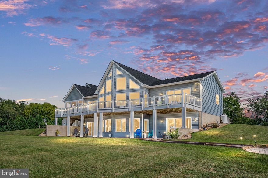 ***WATER VIEWS AND COVERED DEEDED BOAT SLIP***  This 4-bedroom, 2.5-bath home offers stunning water views and an open floor plan. The property boasts soaring ceilings throughout, with a cathedral ceiling in the Great Room, which also features hardwood floors and a gas fireplace. The main level master suite includes two walk-in closets, a cathedral ceiling, and sliding doors to the deck with lake views. The master bath is well-appointed with a double vanity, a soaking tub, and a separate shower. The second bedroom is very spacious and also has a cathedral ceiling.  The kitchen has been recently remodeled with Kraft Maid cherry cabinets, Quartz countertops, and a tiled backsplash. It includes upgraded stainless steel appliances, oversized cabinets and drawers, three lazy Susans, and a built-in bread box. The dining room, also on the main level, is spacious and features hardwood floors. Additionally, there is a half bath on this level. A large screened-in porch offers great views of the lake.  The full finished walkout basement, with LVP floors, features a rec room with fantastic views that would be ideal as a game room or a second living room, complete with a pellet stove. The third bedroom in the basement has a large closet and views of the lake, while the fourth bedroom is enormous, with room for several beds and sliders that lead out to the patio and fire pit area. There is also a full bath with a tub/shower combo on this level, as well as a large unfinished area for ample storage, a commercial washer and dryer, a water filtration system, and some built-in cabinetry and shelving.   Great views from almost every room!   Recent upgrades to the home include two new zoned heat pumps installed in 2023, recently replaced roof and vinyl siding on both the house and the outbuilding. UVB protection has been added to the windows on the lakefront side of the first floor, and custom blinds have been installed. The home is also wired for a generator.  The outbuilding has been doubled in size and includes electricity. The backyard is enclosed with a split rail fence, making it perfect for pets, and there is a paved driveway. The house sits on a corner lot with fantastic lake views and is a short distance from the common area where your deeded covered boat slip with lift is located. Additionally, there is an option to lease a jet ski ramp for an additional fee.   High speed internet is available.  Long View Shores is a small community with upscale homes and great neighbors!  Conveniently located near The Boardwalk with Tim's Seafood Restaurant, mini golf and The Moo Thru.  Just a short distance to the Food Lion shopping center.  You won't want to miss out on this beauty!