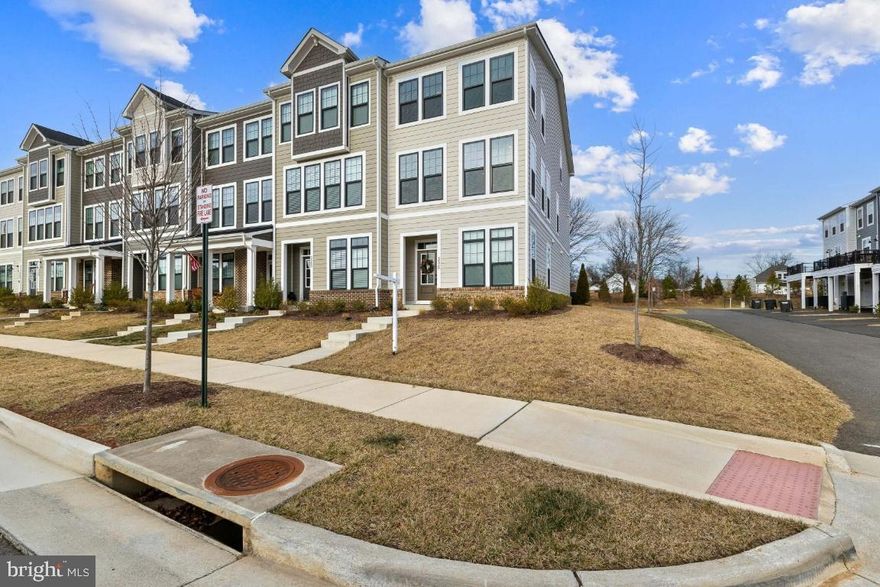 Nestled in the charming community of Heritage at Marshall, this exquisite end-of-row townhouse offers a perfect blend of modern elegance and cozy comfort. Built in 2023, this home boasts a Colonial architectural style, featuring a stunning combination of brick and HardiPlank siding that enhances its curb appeal. Step inside to discover a thoughtfully designed interior that caters to both relaxation and entertaining. The open floor plan seamlessly connects the family room and dining area, creating a warm and inviting space for gatherings. Walk out to your beautiful maintenance free deck. Natural light pours in through energy-efficient, insulated windows, illuminating the luxurious vinyl plank flooring and plush carpeting in bedrooms. The gourmet kitchen is a chef's dream, equipped with stainless steel appliances, upgraded quartz countertops, and a spacious island that invites culinary creativity. Upstairs, you'll find three generously sized bedrooms, including a primary suite that offers a private retreat with a walk-in closet and an en-suite bathroom featuring a walk-in shower and double vanity. Each additional bedroom is well-appointed, ensuring comfort for everyone. Spacious Hall Bath with a tub and shower.  HomeTeam pest service in place-home is wired for easy treatment! Outside, the community amenities are a true highlight. Enjoy sunny days at the in-ground community pool, take leisurely strolls along the jog/walk paths, or gather with neighbors at the clubhouse. The well-maintained common areas and playground make this community a delightful place to call home. Parking is a breeze with an attached garage, driveway, and additional off-street options. The exterior features include sidewalks and street lighting, enhancing the neighborhood's charm and safety. This home is not just a property; it's a lifestyle. With its modern conveniences, beautiful surroundings, and community amenities, it's the perfect place to create lasting memories. Don't miss the opportunity to make this inviting townhouse your new home!