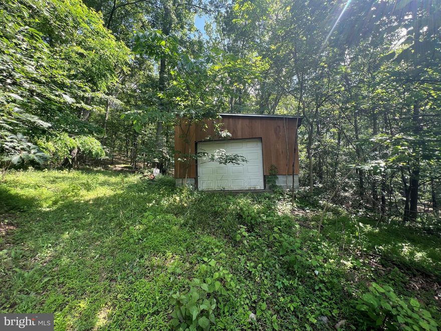 WOW ! What a find 16.61 UNRESTRICTED  acres w/hardcap road frontage, a one-car detached garage, a shed , well/septic and a block foundation. This is a great location in the geographical center of Hampshire co w/ easy access off a paved road .Land is wooded and home site is not far from the paved road. There was a home on the block foundation which burned down in 2020 .You could use the current foundation and rebuild or build elsewhere on the property but land like this is nearly impossible to find with all the infrastructure in place to construct your WV dream house . This is a great property  so come to Wild, Wonderful ,Hampshire co WV where Mountaineers are always free and find your freedom !!