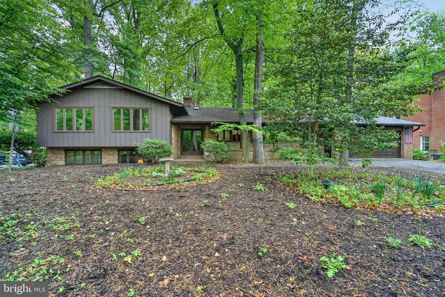 Opportunity awaits! Don’t miss out on this well-built spacious brick home with an oversized two car garage perfectly situated on a half-acre lot in the desirable community of Longfellow, Harper’s Choice, Columbia. Tucked away toward the back of the neighborhood minutes from paved walking and biking trails and the vibrant Merriweather district, this home is convenient yet private. It boasts a total of 4,426 square feet of space with 3,390 being improved above grade and another 1,036 below for recreation, storage and utilities. Left of the main entry foyer, upon entering, you will find an updated and upgraded 239 sq ft kitchen with expansive stone counter tops and tons of functional cabinetry. Past the kitchen this stately home opens to a generously sized living room accentuated by a stunning floor to ceiling, windows and brick wall with wood burning fireplace. The spacious formal dining room overlooks its secluded backyard. After dinner, retire and relax in your own personal haven. A naturally heated sunroom supplemented by a cozy wood stove for colder months. A few steps up from the main level you will find the primary suite with en-suite bath as well as three large secondary bedrooms sharing a center hall bathroom. Open to, and just a few steps down from the main level, you and your family and friends will enjoy gathering in the large family room boasting a stylish retro bar and a second brick fireplace accented by a wall of windows and a sliding glass door leading to the fenced backyard. Off of the family room you will find two additional rooms which can be reimagined as offices, hobby or play spaces along with a half bath. The second lower level has even more space for recreation and storage, including a cedar closet, laundry and an additional workshop. Priced below market, this home is sturdy and ready to easily be refreshed! The roof was replaced in 2015 but the property is being offered as-is affording a rare opportunity to a savvy buyer! Columbia residents enjoy easy access and reduced fees to the association’s extensive amenities, including gyms, pools, parks, lakes, walking paths and other recreational facilities. Conveniently located almost mid-way between Baltimore and DC near a multitude of restaurants, shopping, top-rated schools, major commuter routes and the Baltimore Washington International Airport. Offering the perfect combination of location, space and opportunity. This home won't last long. Visit an open house or schedule an appointment to tour it ASAP!  Offer's due Tuesday May 5th.
