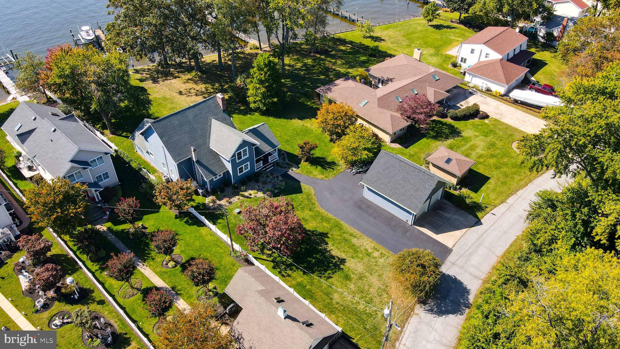 OPEN HOUSE SATURDAY MARCH 11 , 11AM - 1PM! Welcome to 2003 Park Drive located in Pasadena Maryland. This one-of-a-kind property sits on the Bodkin river with quick access to the Chesapeake Bay with many boating destinations including Annapolis, Baltimore, Rock hall, Kent narrows and Millers Island. The property features a new deep water pier with electricity, running water and lighting that hosts 4 lifts including two jet ski lifts, one twenty-five thousand pound lift and one ten thousand pound lift. There is also a slip that holds up to a 35 foot boat.
This double lot features 100 feet of waterfrontage with mature trees that provide plenty of shade to enjoy summer evenings in your gazebo. The patio and porch make great space for entertaining guests, as well as freshly installed landscaping with river rock for low maintenance and great curb appeal. Parking is made easy with a large driveway and parking pad. The oversized 2 car detached garage also includes an electric vehicle charging station! Never worry about power outages again with the 20KW propane powered generator that runs both zones of electric, including the garage, pier, all appliances and HVAC systems.
Walk inside through the oversized kitchen to the large living room with a gas fireplace to keep the family cozy on cold nights. The main living area boasts an open floor plan with bar height counters with a full water view. The main level has 3 bedrooms and one and a half baths. The primary bedroom on the main level overlooks the creek.
Travel upstairs to the second story that features an oversized primary bedroom. The primary bedroom features two generous walk-in closets, one with built in shelving and cabinets. There is a second bedroom upstairs as well as a full bath that can be accessed from both bedrooms. This amazing waterfront property won’t last long! Schedule your showing today.